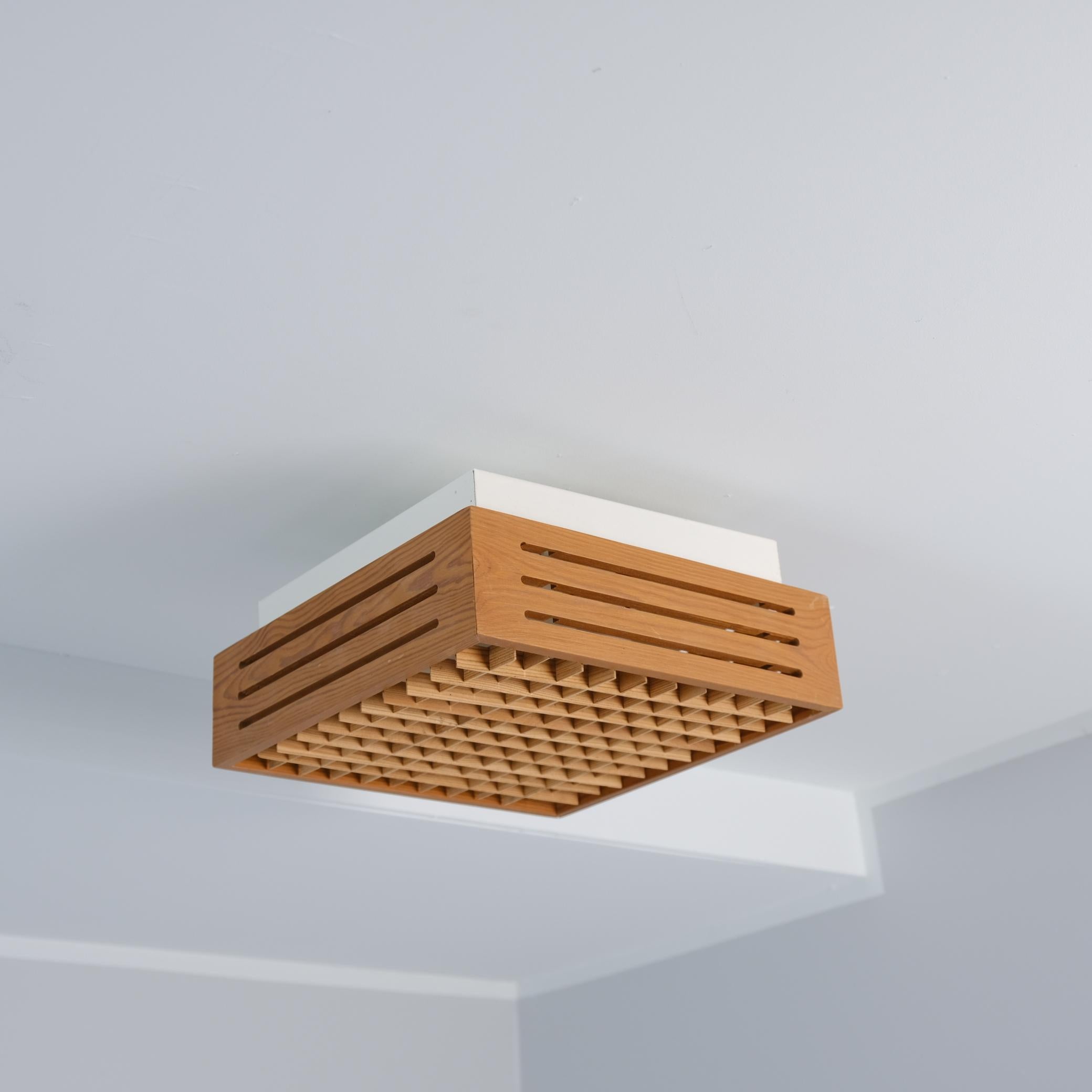 Handsome modernist flush mount ceiling lamps crafted from solid pine with white metal bases, imported from Sweden to Finland in the 1970s-80s by Stockmann Orno Tukku and originally sold through the prestigious Stockmann department store.

Each lamp