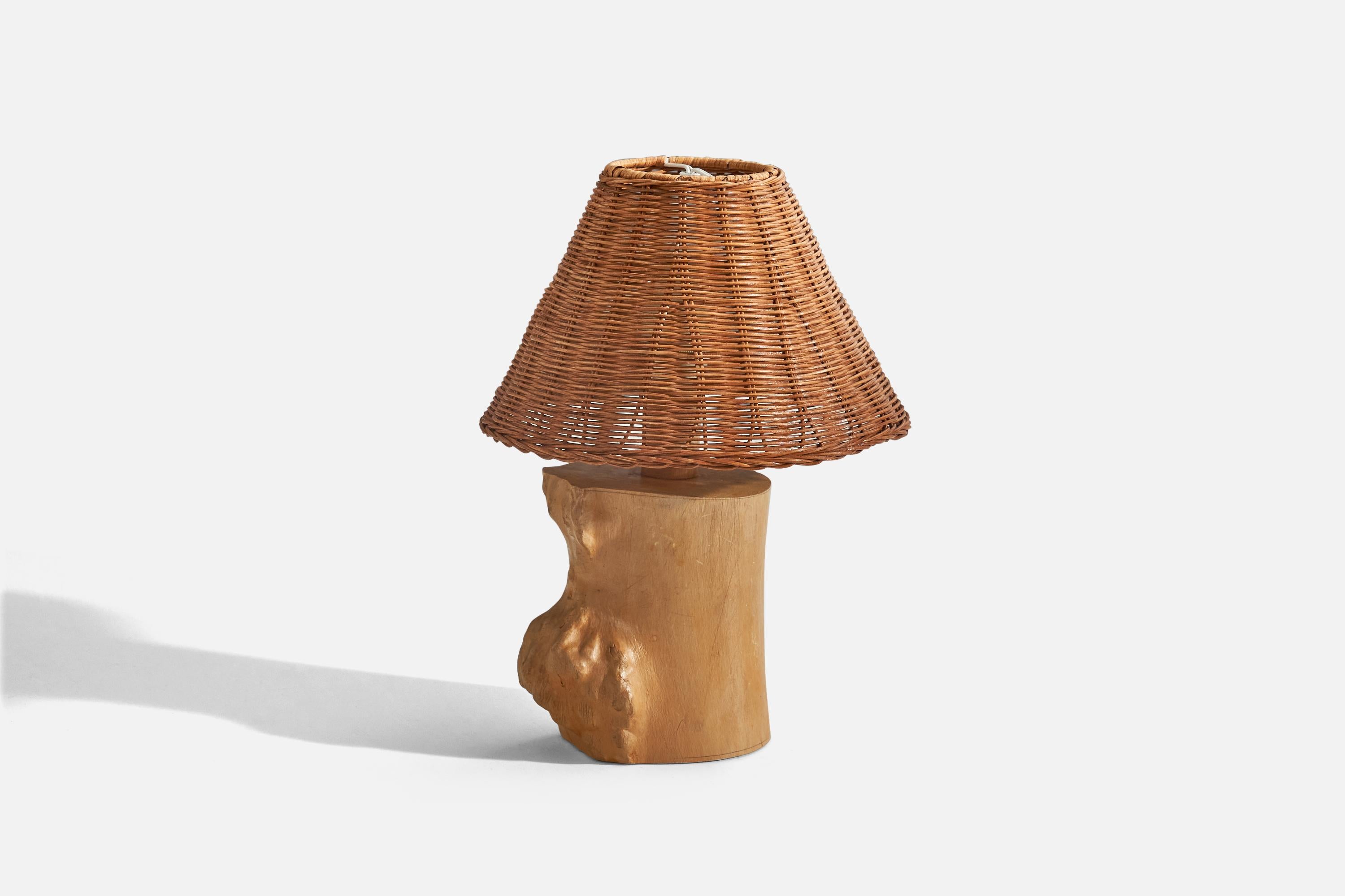 A freeform wood and rattan table lamp designed and produced in Sweden, initialed by artist and dated 1963.

Sold with lampshade. 
Dimensions of lamp (inches) : 9.62 x 5.35 x 4.15 (height x width x depth)
Dimensions of shade (inches) : 3.12 x