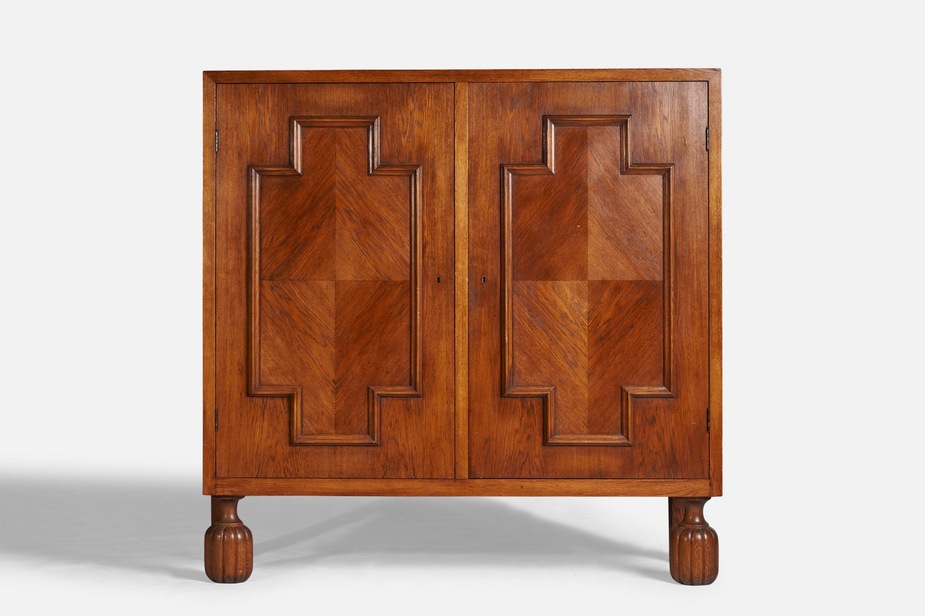 A large stained oak cabinet designed and produced in Sweden, 1930s.