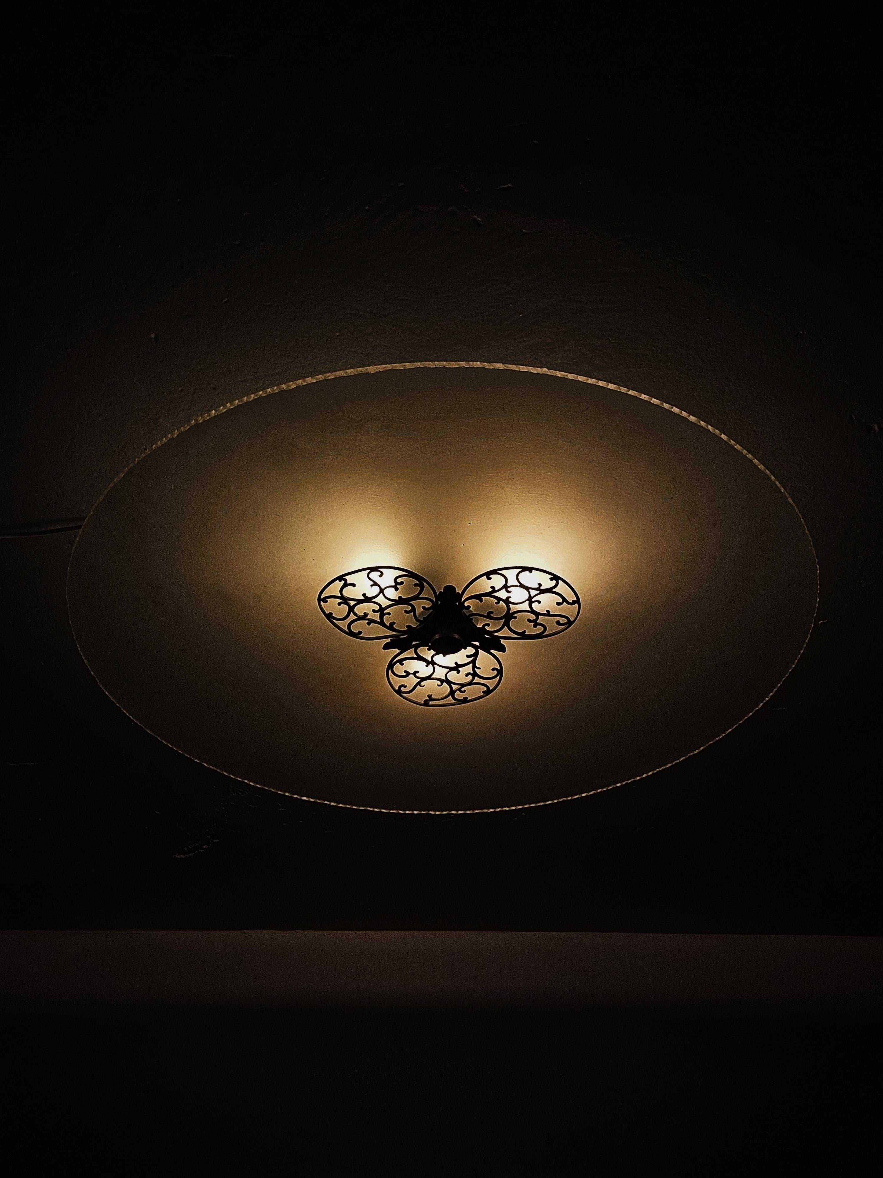 Monumental flush mount made by anonymous designer in the first half of the 20th century.

Goes well under the style Swedish Grace that was celebrated in the design world during the 1930s. 

Made in glass with beautiful oxidized copper details.