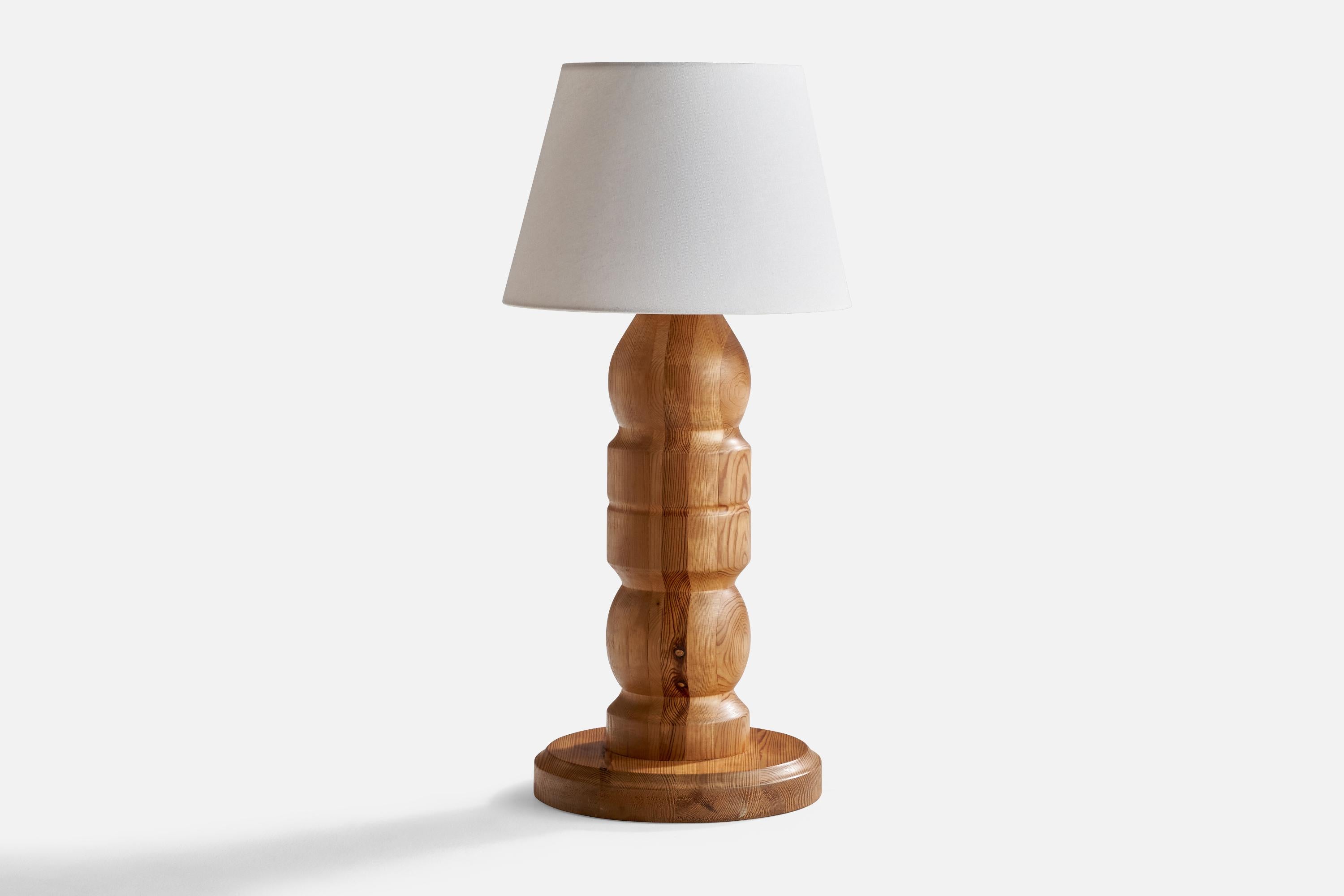 A large pine table lamp designed and produced in Sweden, c. 1960s.

Dimensions of Lamp (inches): 22.75” H x 11.5”Diameter
Dimensions of Shade (inches): 9.5” Top Diameter x 14