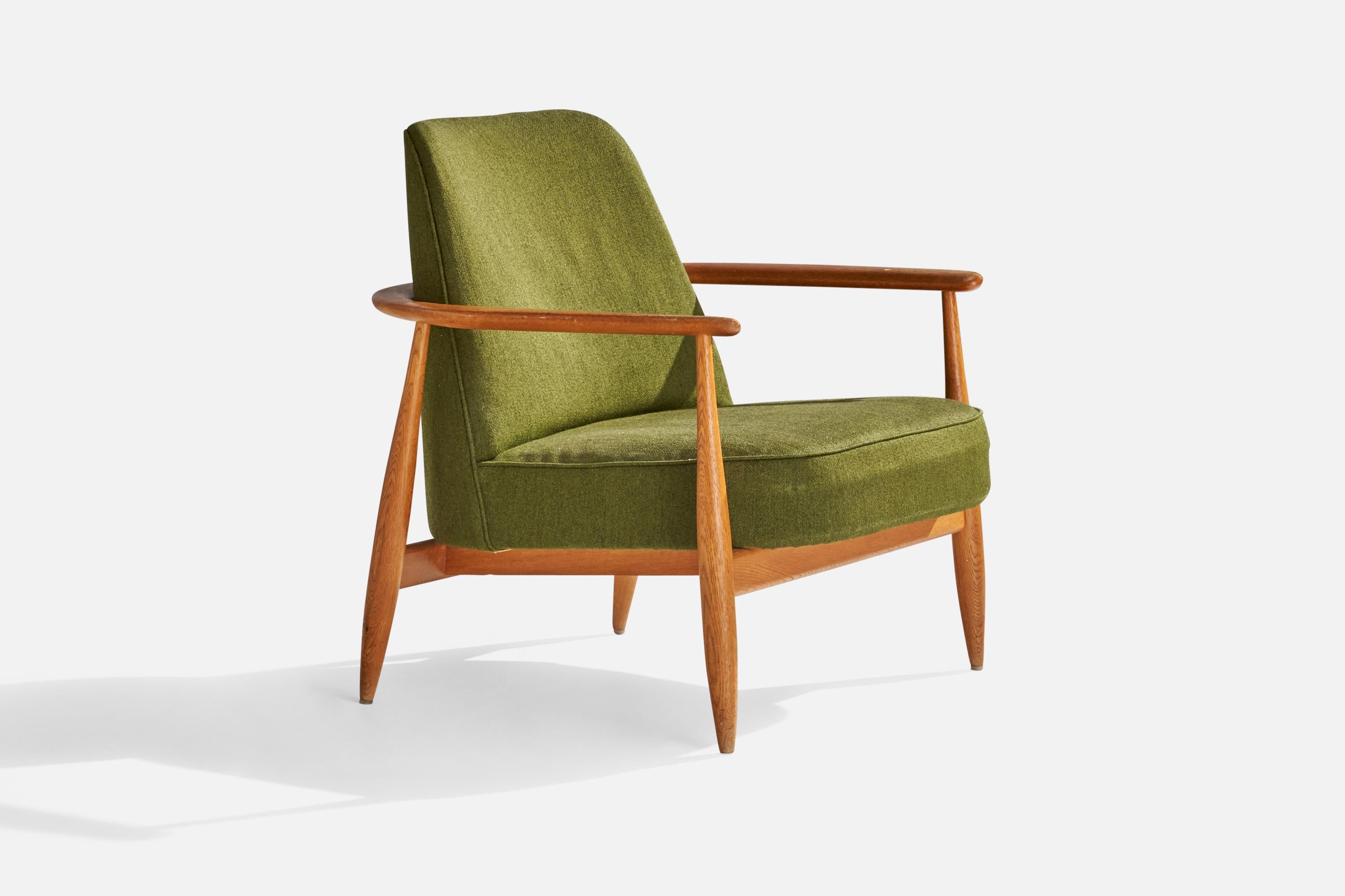 An oak and green fabric lounge chair designed and produced in Sweden, c. 1950s.

seat height 15.5” 