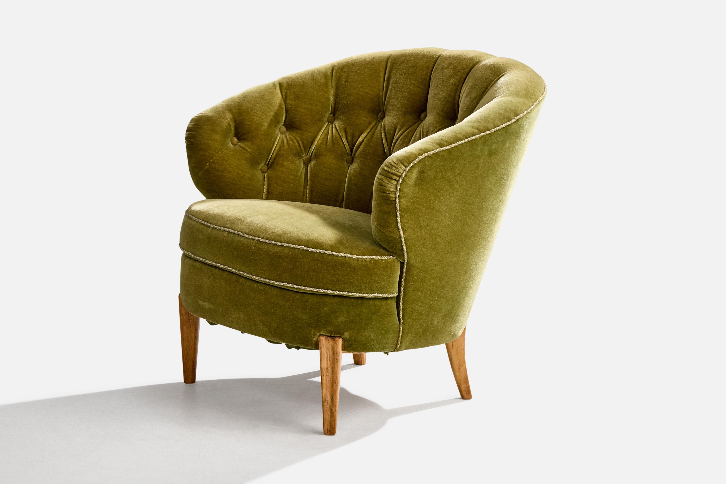 A green velvet and oak lounge chair designed and produced in Sweden, c. 1940s.

Overall Dimensions (inches): 30.0