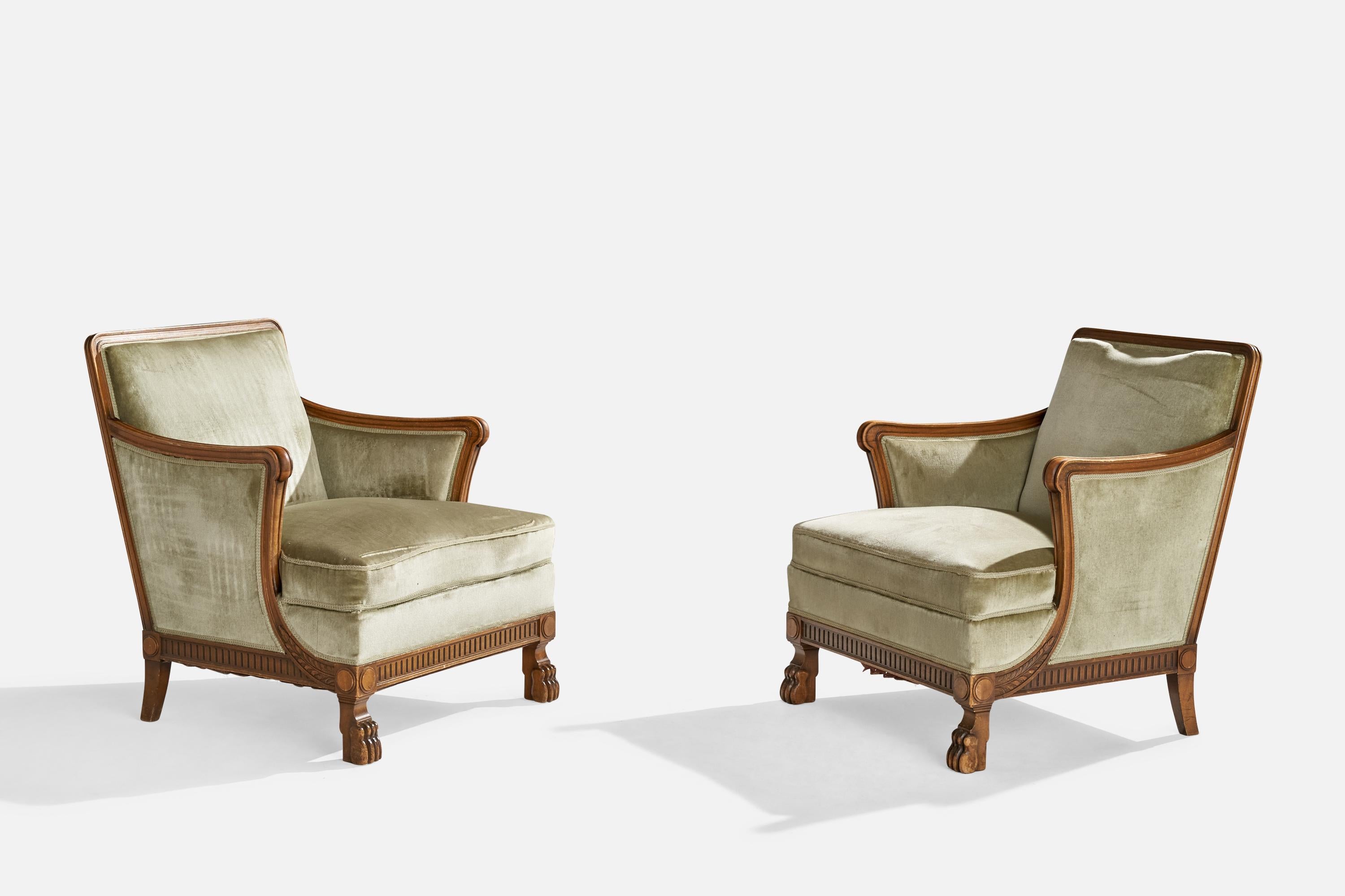 A pair of stained oak and green velvet lounge chairs designed and produced in Sweden, c. 1930s.

Seat height: 17.5”
