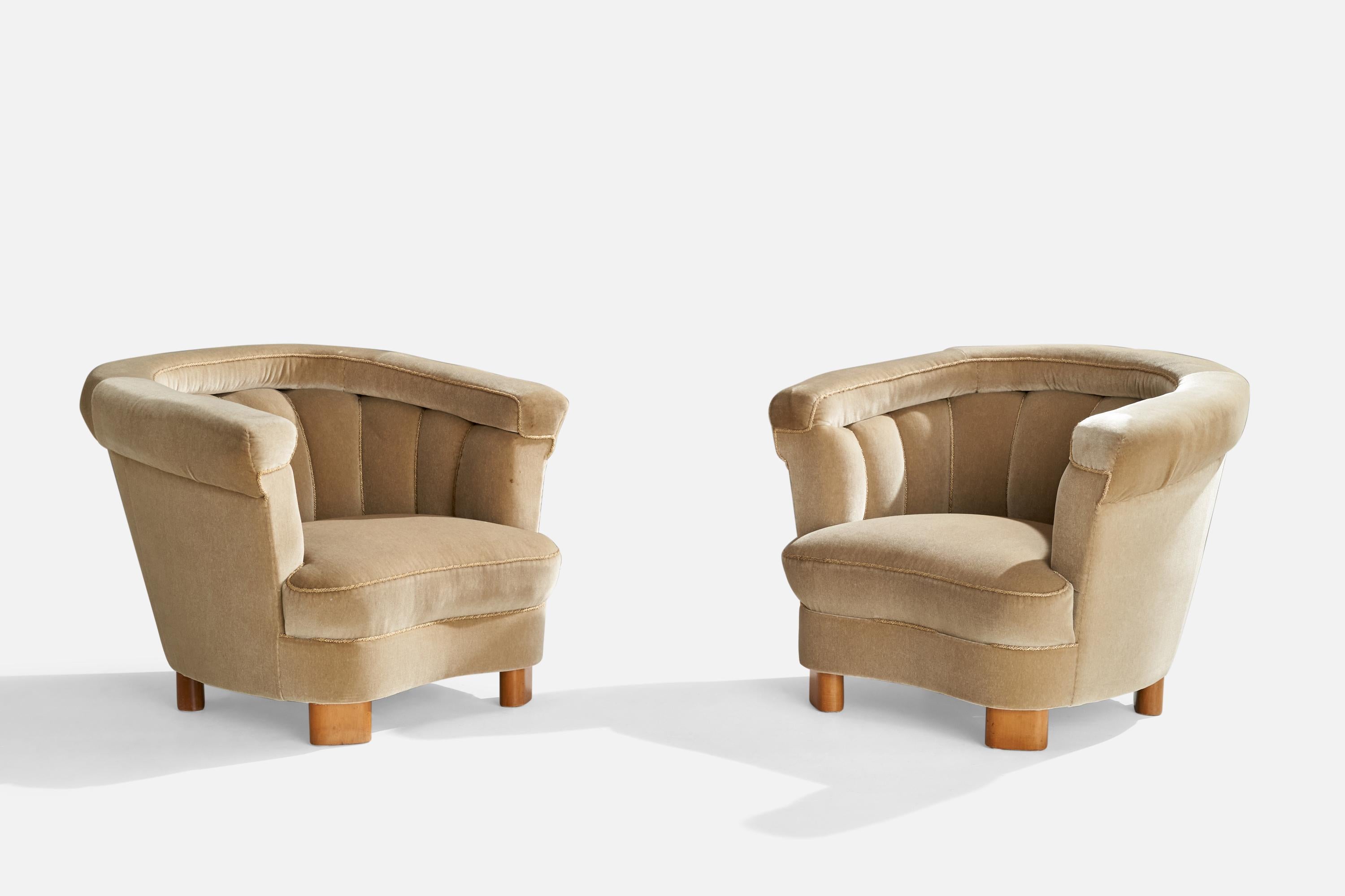 A pair of beige velvet and wood lounge chairs designed and produced in Sweden, c. 1940s.

Seat height: 15”

All upholstered furniture can be reupholstered upon request for an additional fee. Lead times will be an additional 1-3 weeks from receipt of
