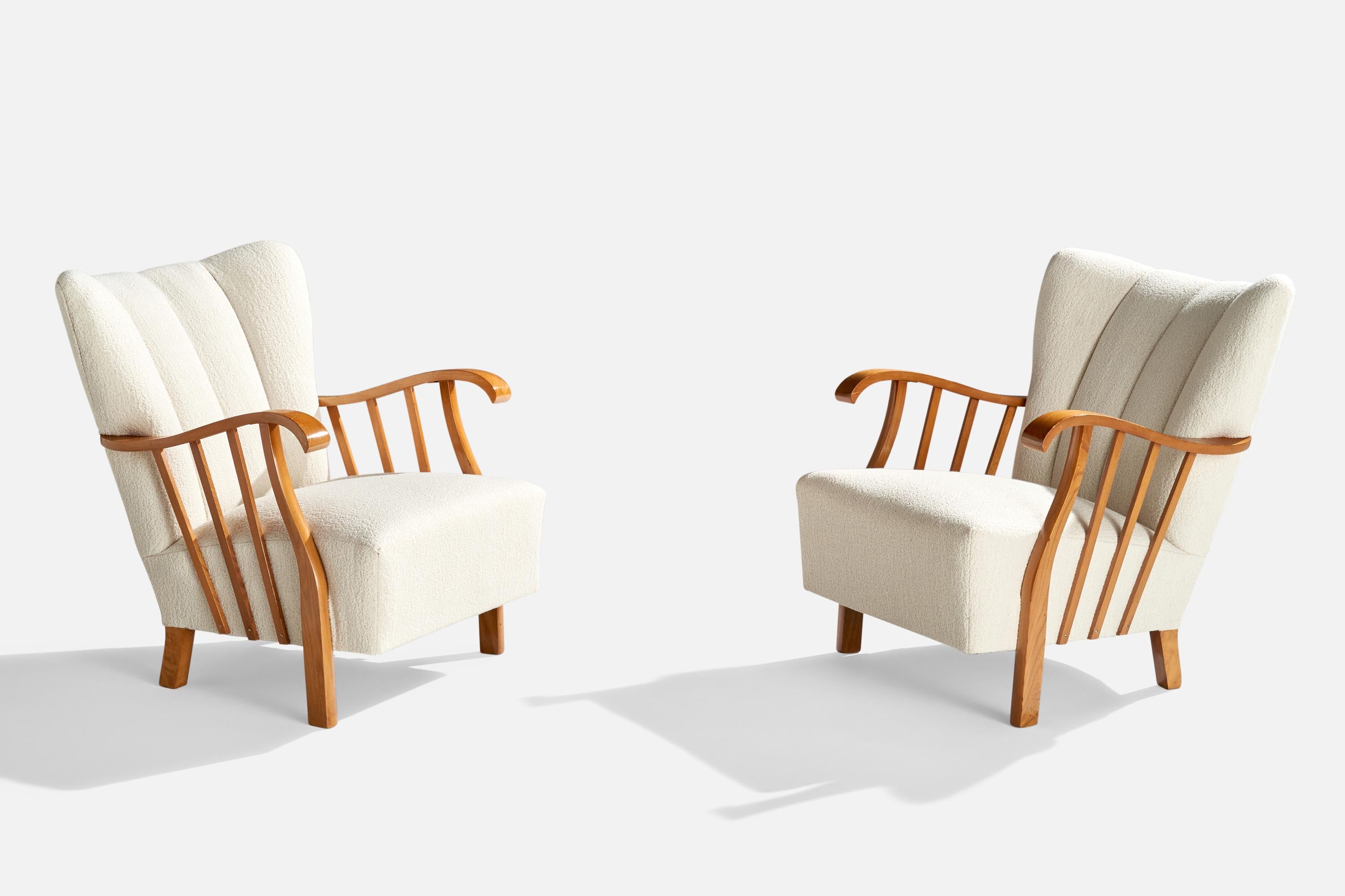 A pair of wood and white fabric lounge chairs designed and produced in Sweden, c. 1940s.

Reupholstered in brand new white fabric. 
