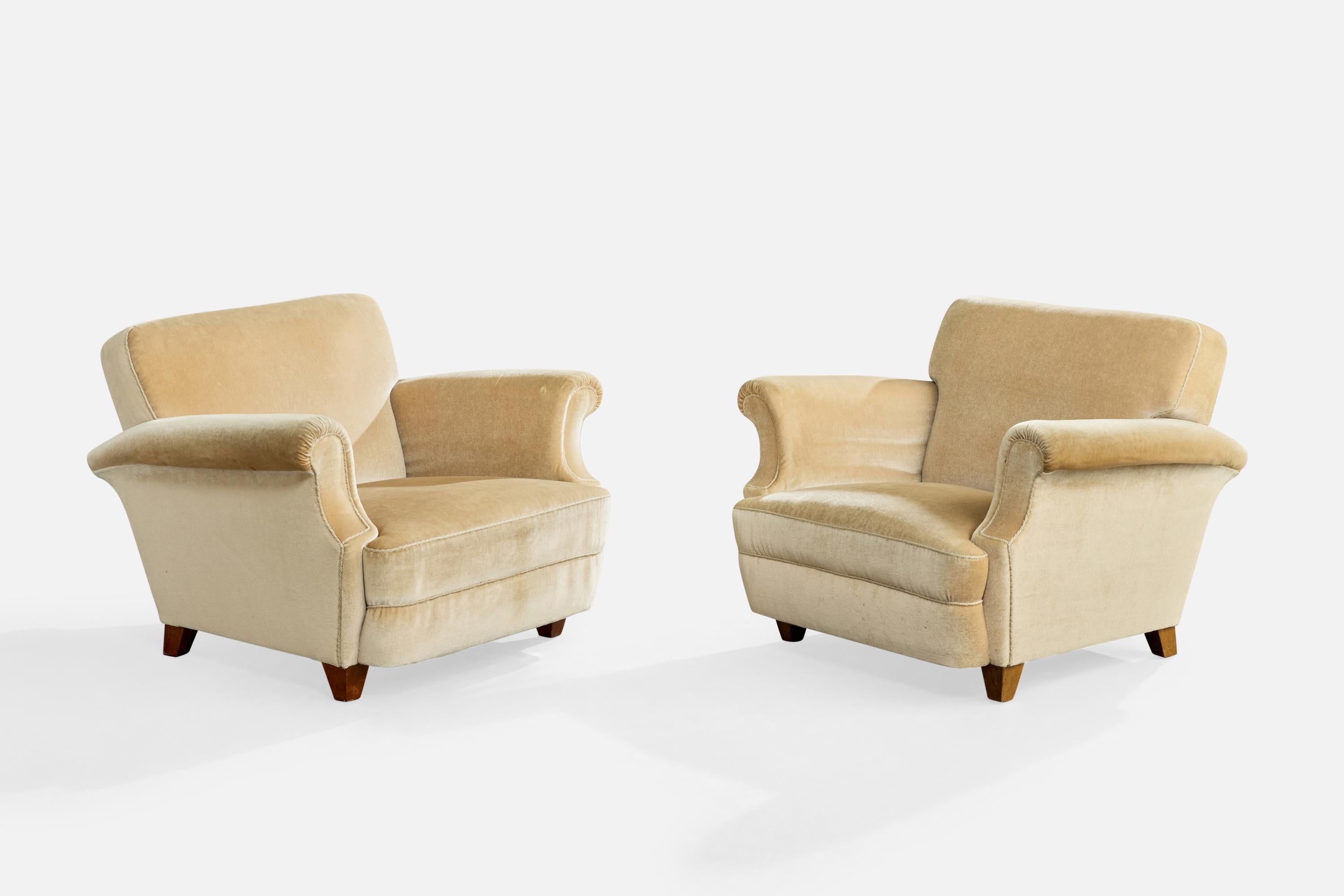 Ein Paar Sessel aus beigem Samt und Holz, entworfen und hergestellt in Schweden, um 1950.

Stoffflecken auf den Armlehnen.

Gesamtabmessungen (Zoll): 29,0 