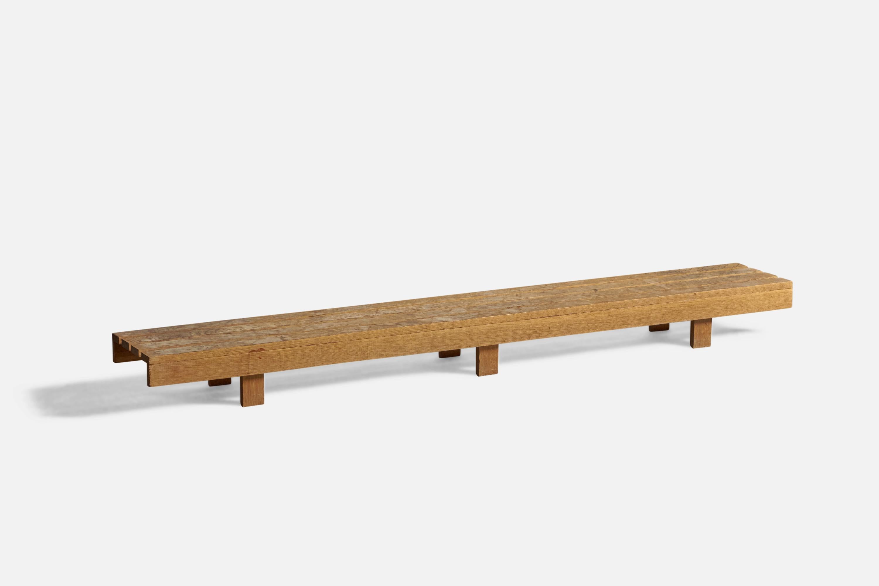 A low pine bench, designed and produced in Sweden, c. 1970s.