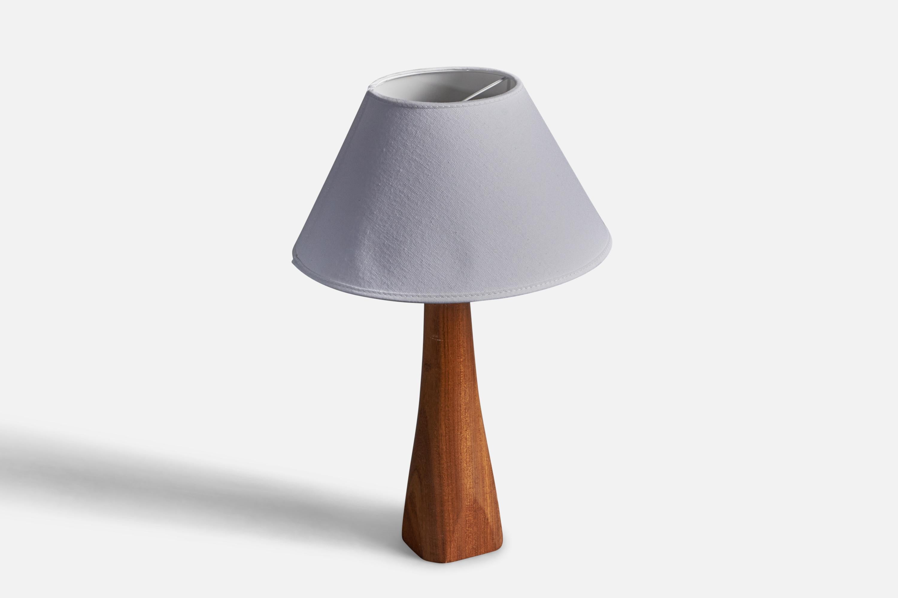 A table lamp. Designed and produced in Sweden, 1960s. In finely sculpted solid teak. Shade not included.

 