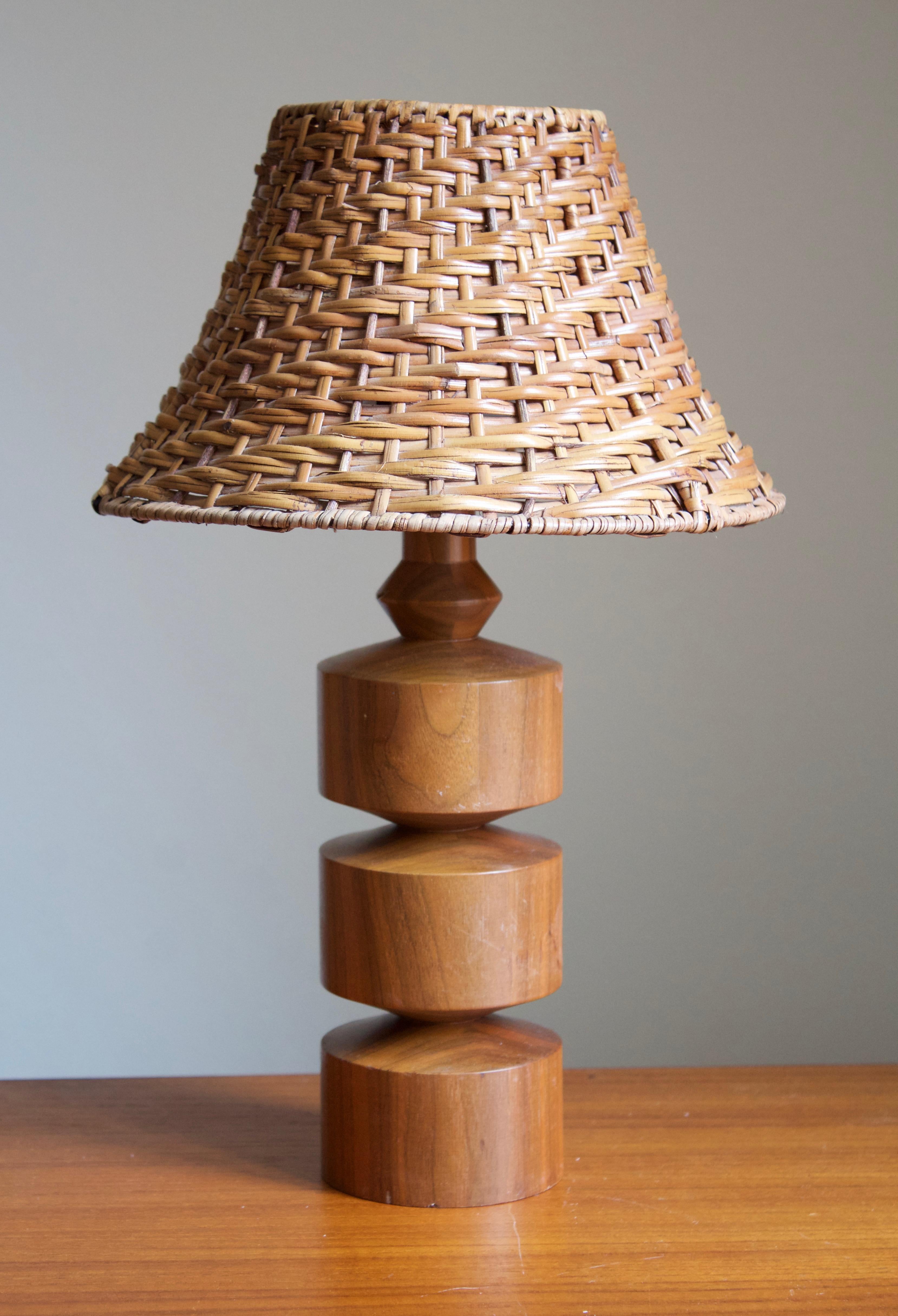 A table lamp. In solid turned teak. By unknown Swedish designer and producer, 1950s-1960s.

Stated dimensions exclude lampshade, height includes the socket. Lampshade of illustrated model can be included upon request.