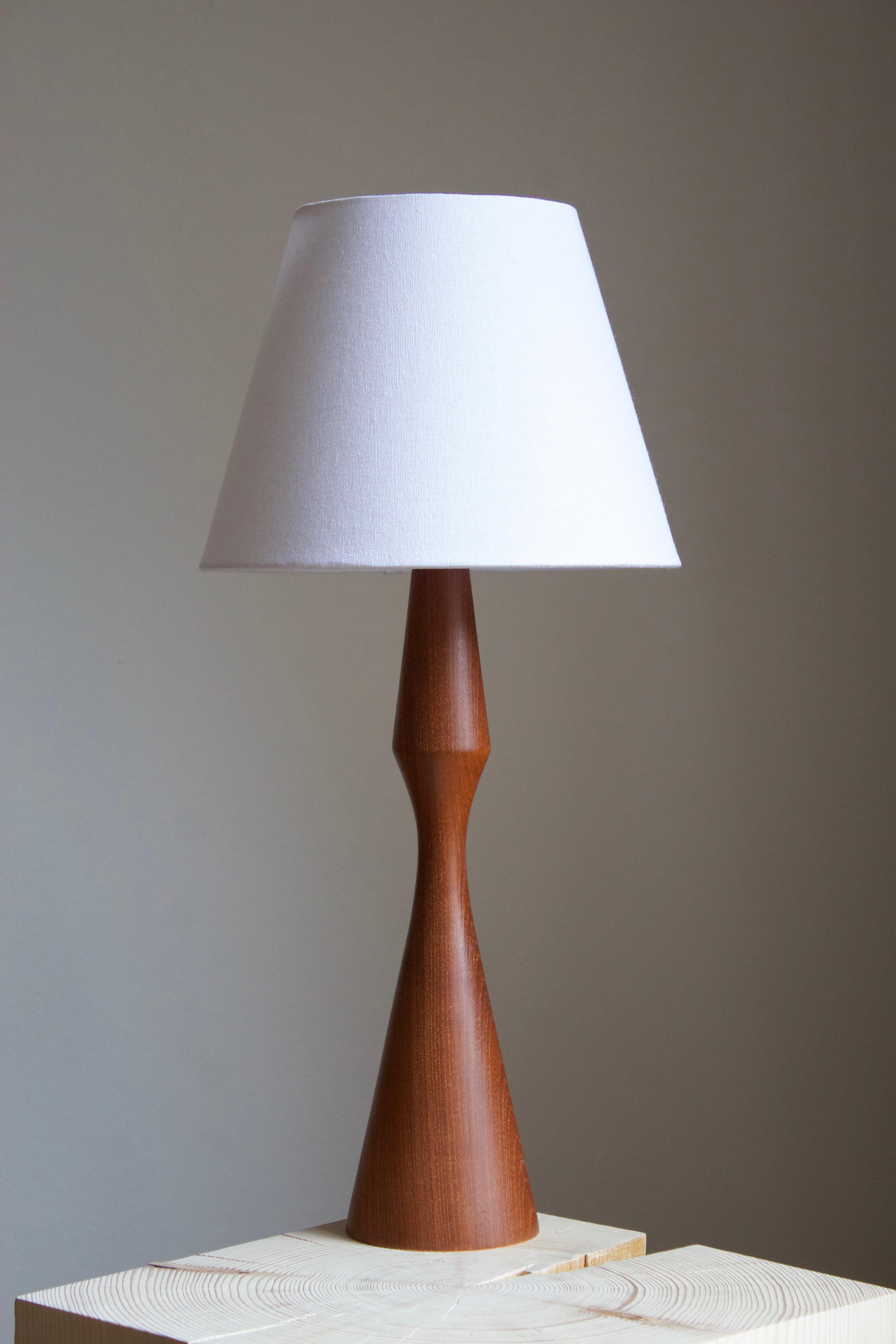 A very large organic table lamp. In solid turned teak. By unknown Swedish designer and producer, 1950s-1960s.

Stated dimensions exclude lampshade, height includes socket. Sold without lampshade.