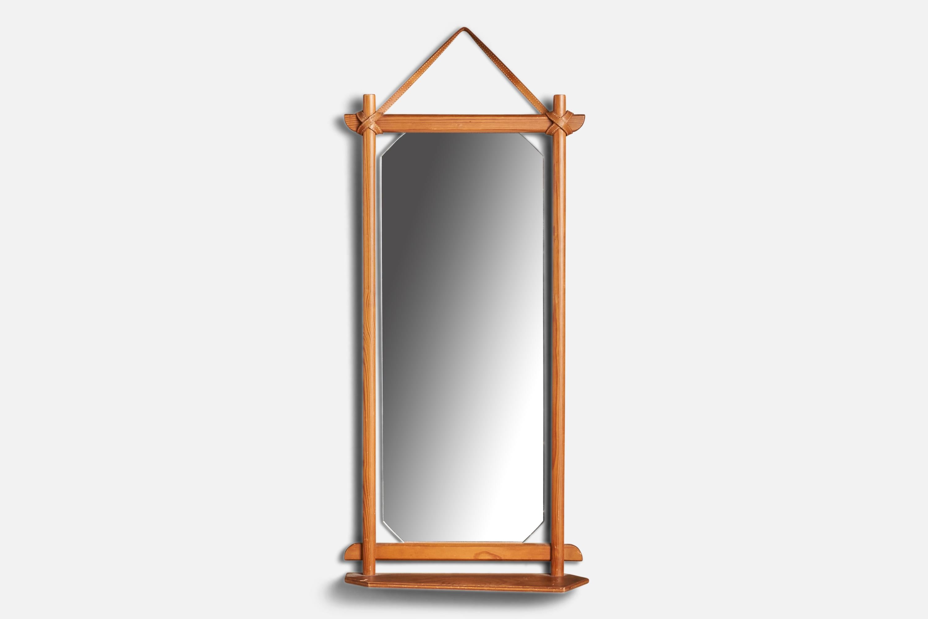 A pine and leather mirror designed and produced in Sweden, 1960s.