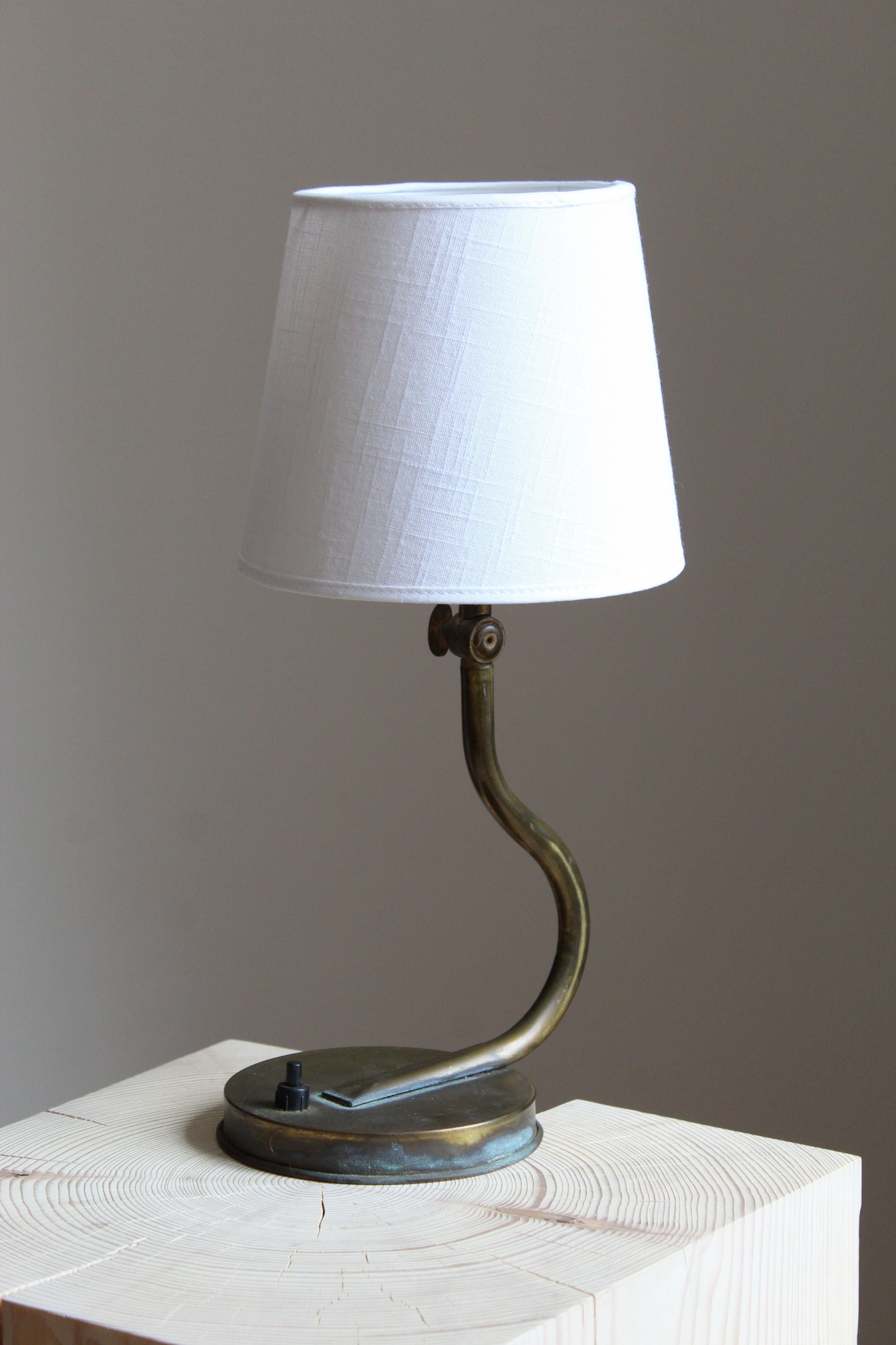 A table lamp or desk light. In brass. Brand new linen lampshade.

Other designers of the period include Josef Frank, Paavo Tynell, Hans Bergström, Böhlmarks, and Jean Royère.