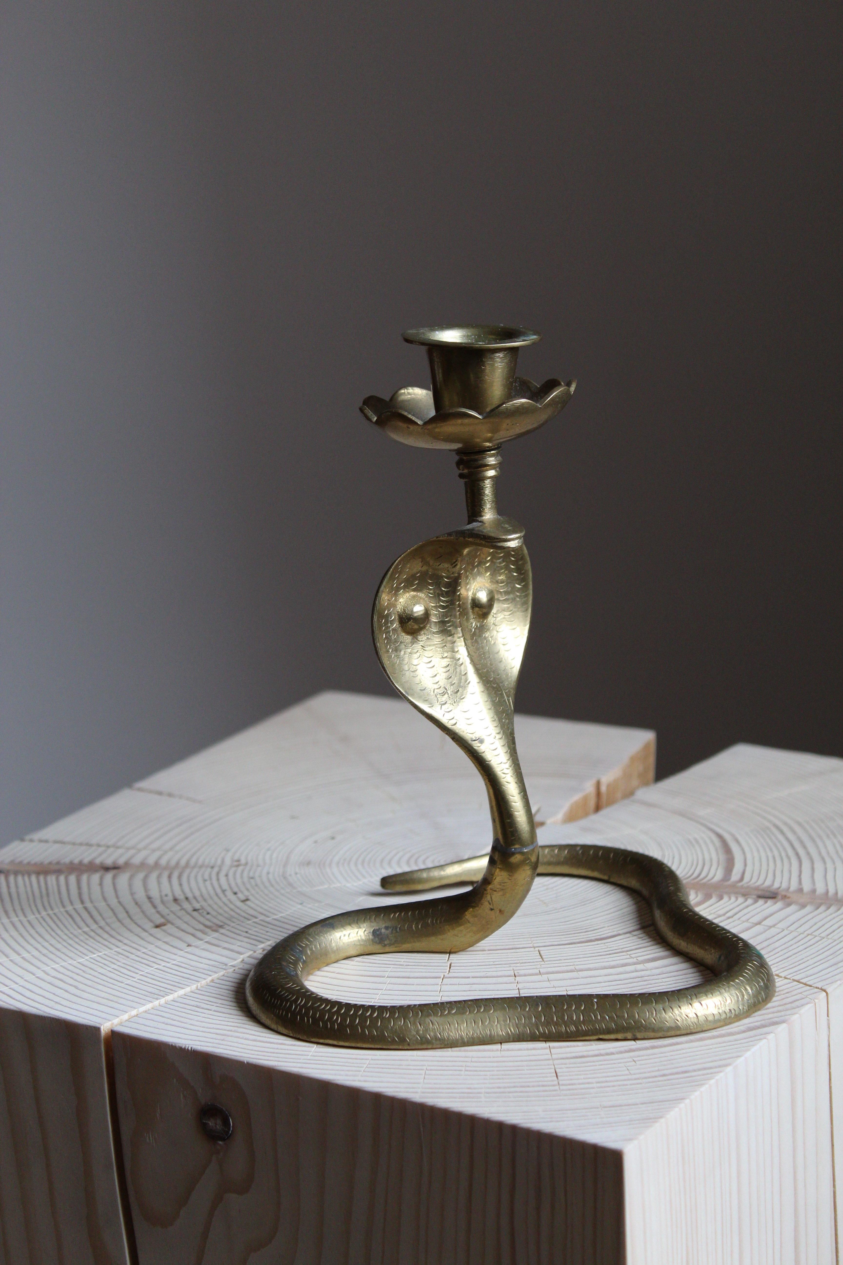 An organic candlestick, in the form of a cobra snake. Likely produced in Sweden, 1940s.

Signed, unintelligible.