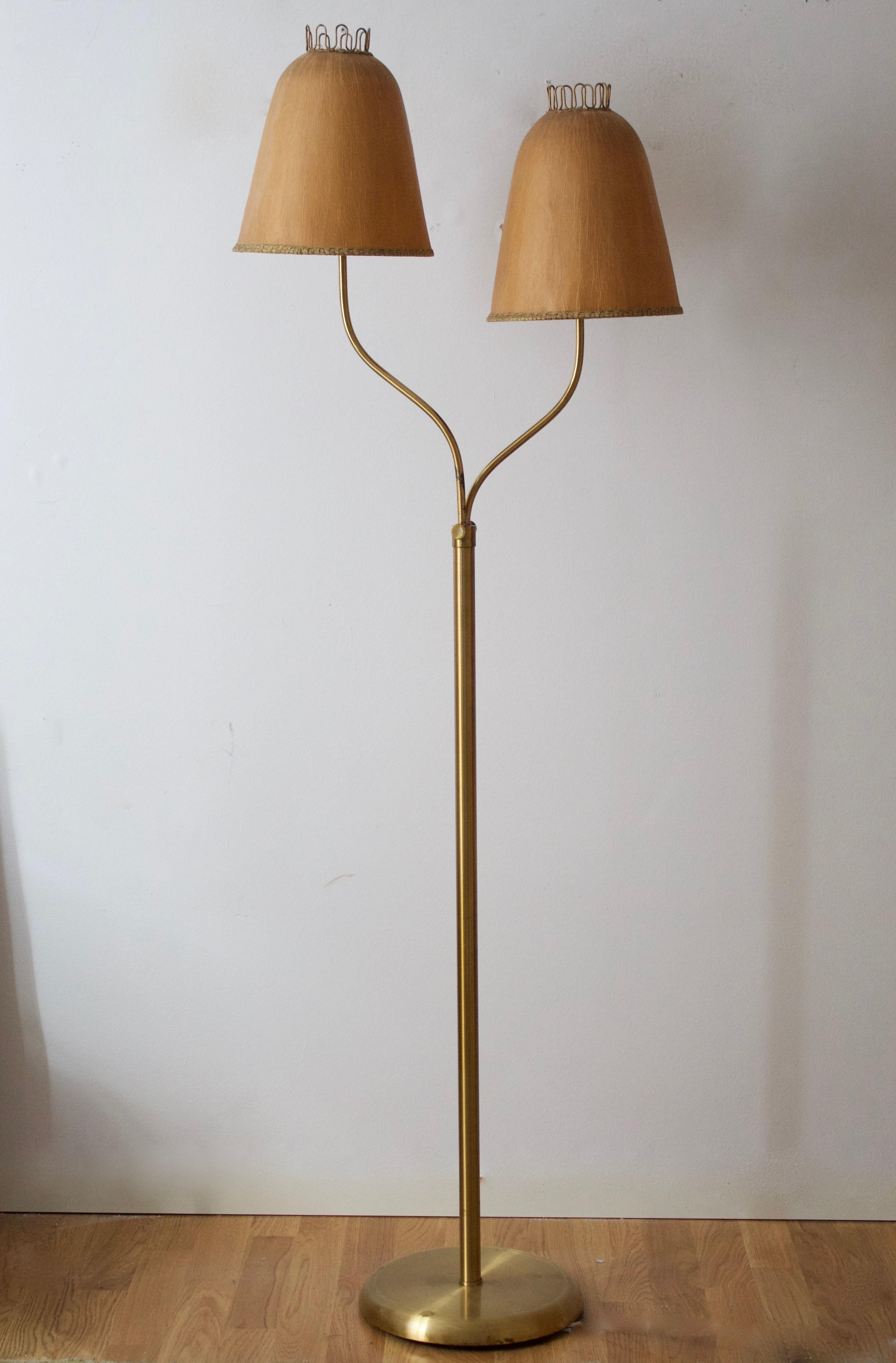 A two-armed floor lamp, designed and produced in Sweden, 1930s-1940s. Features brass, and it's original papier mache lampshades. Dimensions variable

Other designers of the period include Jean Royère, Paolo Buffa, Josef Frank, Jacques Adnet, and