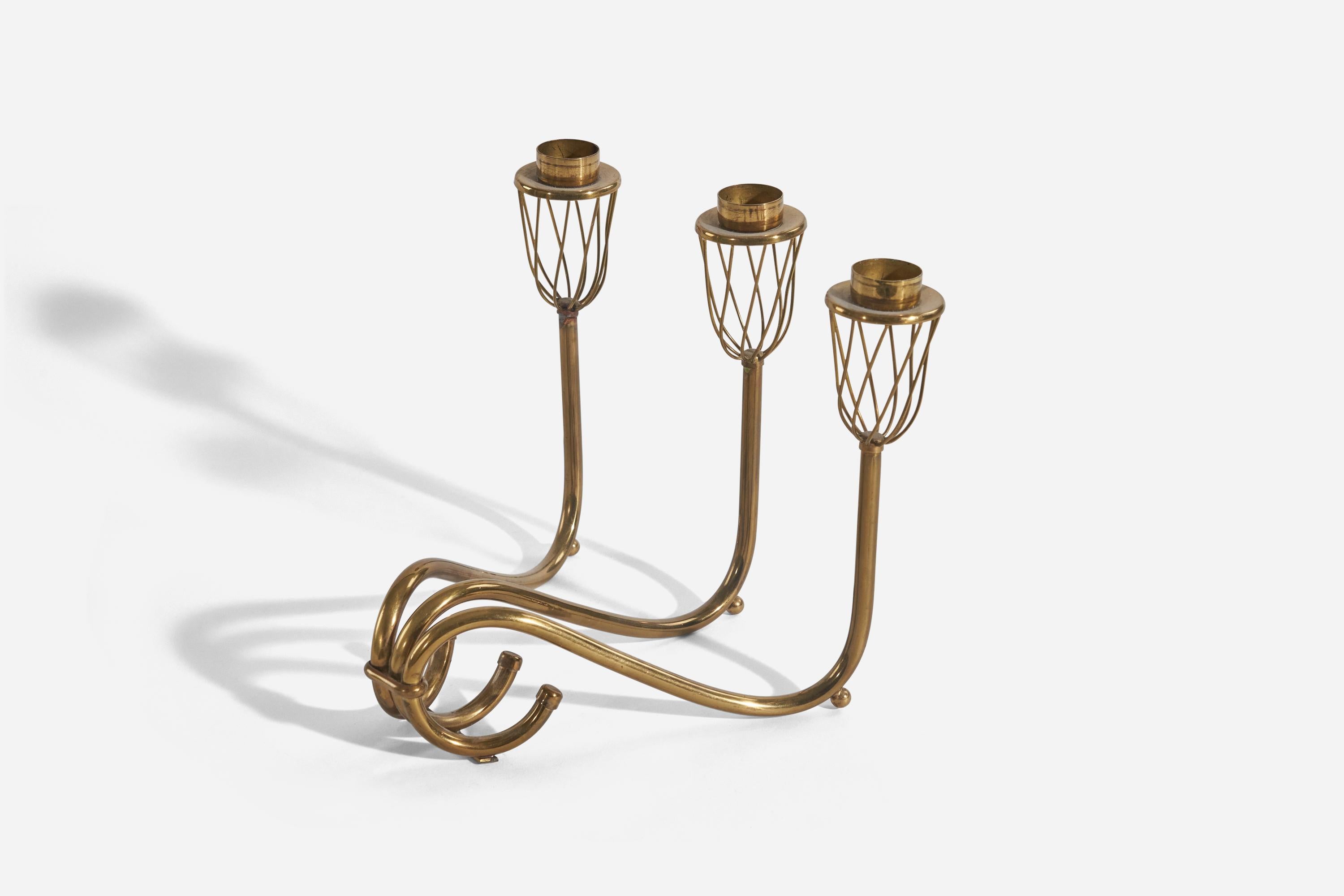 A brass, 3-armed candelabra designed and produced in Sweden, 1940s.

