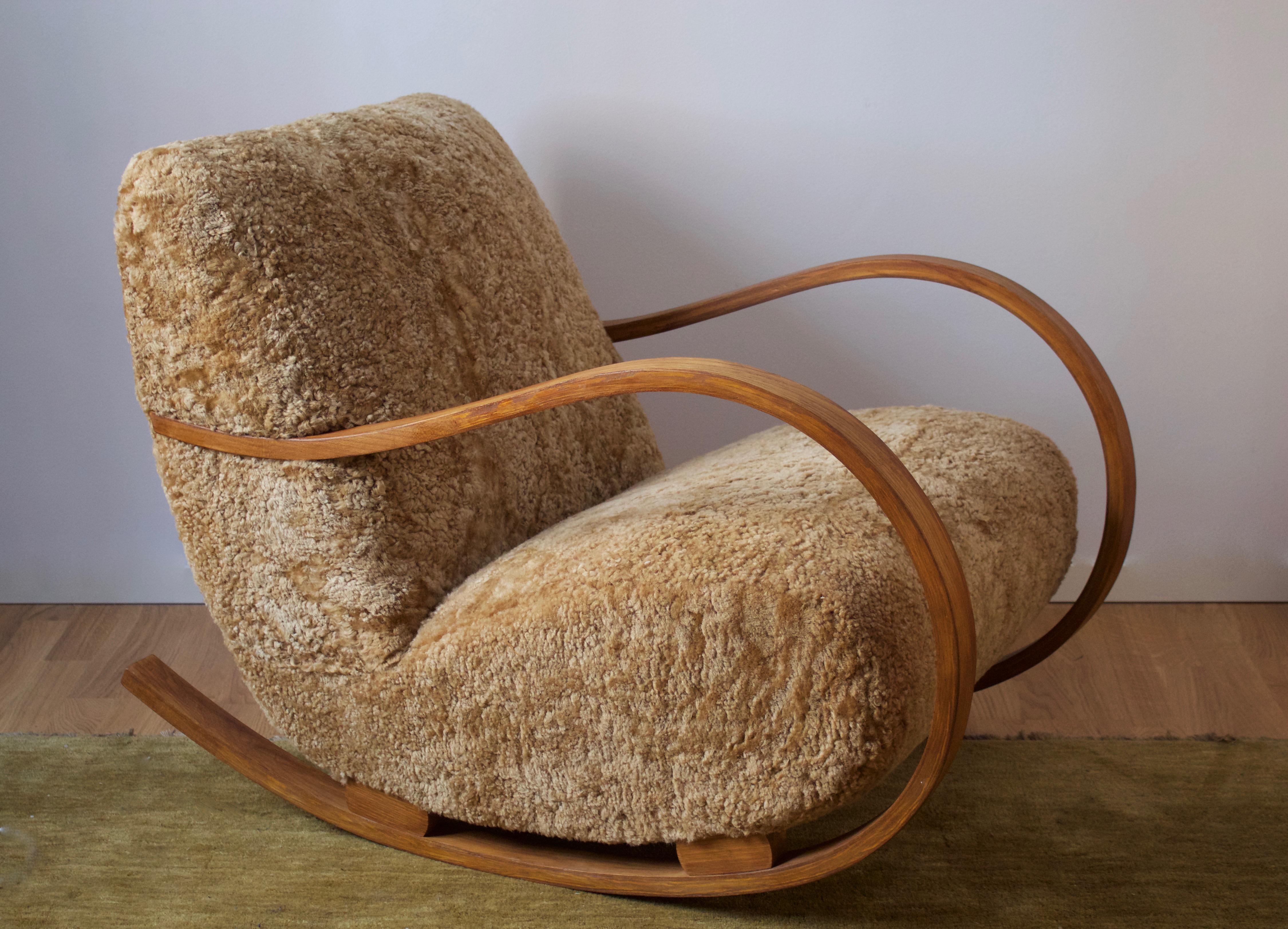 An organic rocking chair / lounge chair. Stained bentwood, reupholstered in brand new high-end sheepskin upholstery.

 