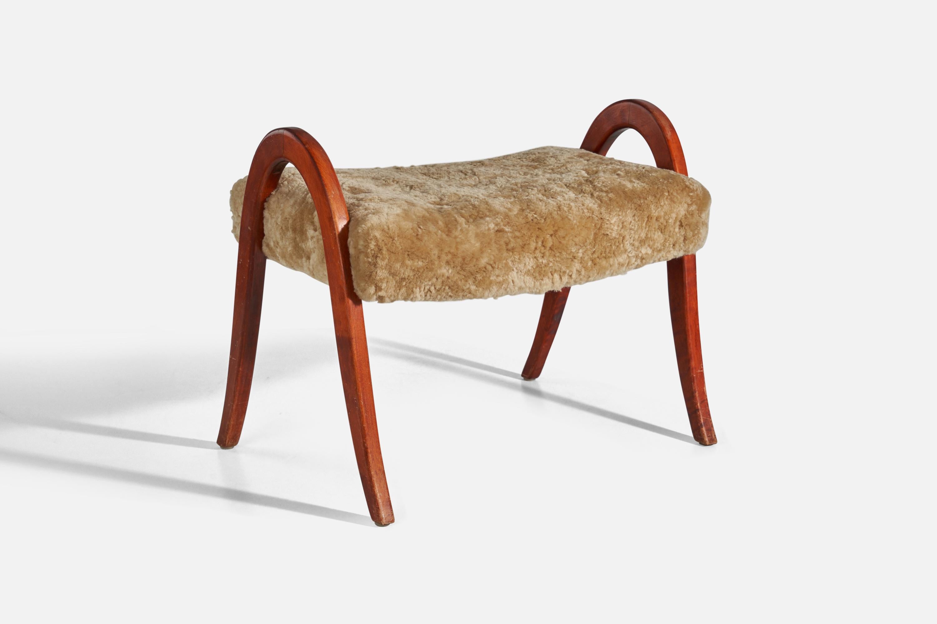 A stained wood a d sheepskin stool designed and produced in Sweden, 1940s.

