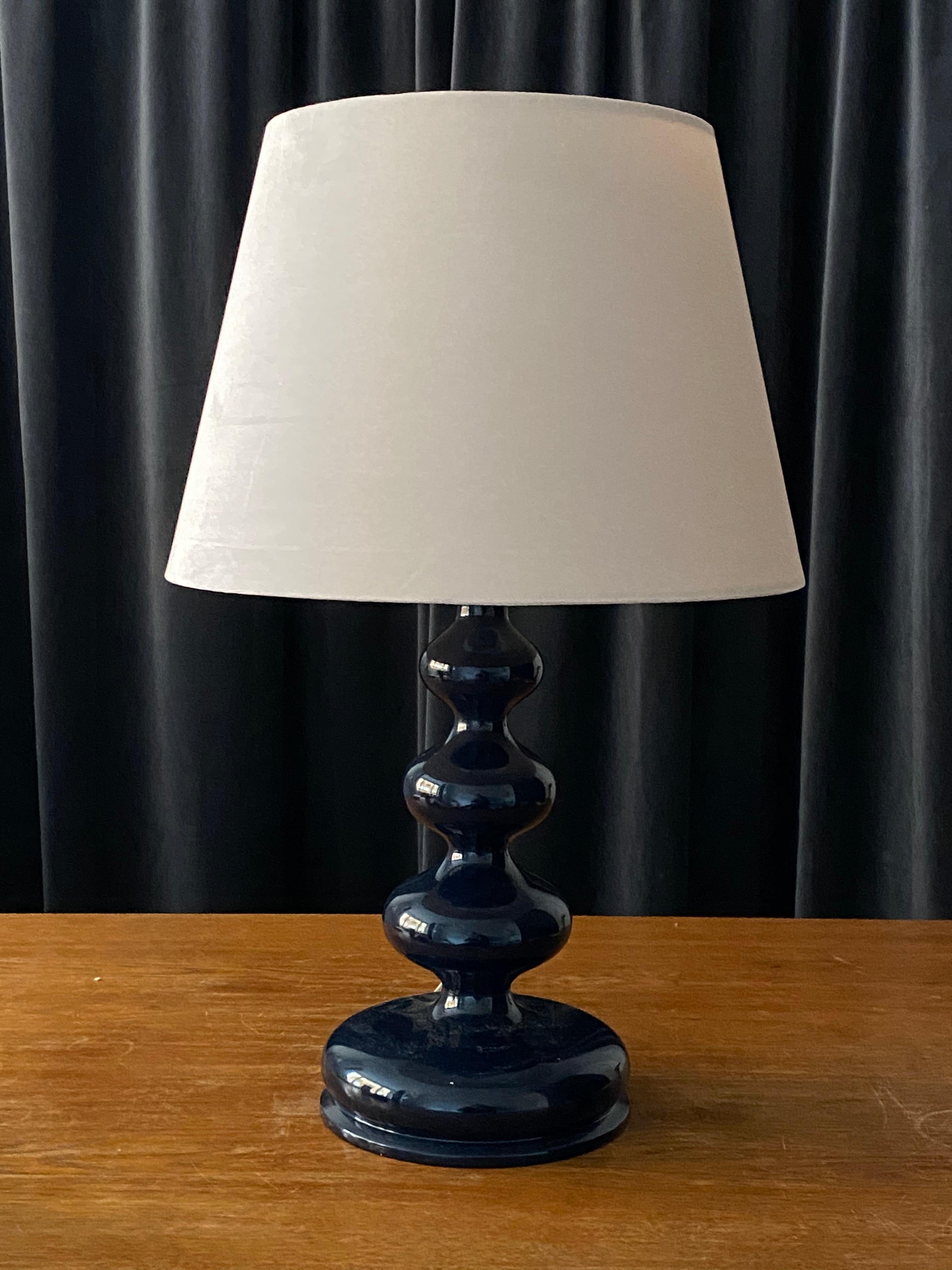 An organic freeform table lamp or desk light. In finely sculpted wood, in original blue lacquer. 

Lampshades are attached for illustration and are not included in purchase, stated dimensions are without lampshades.

Other designers of the