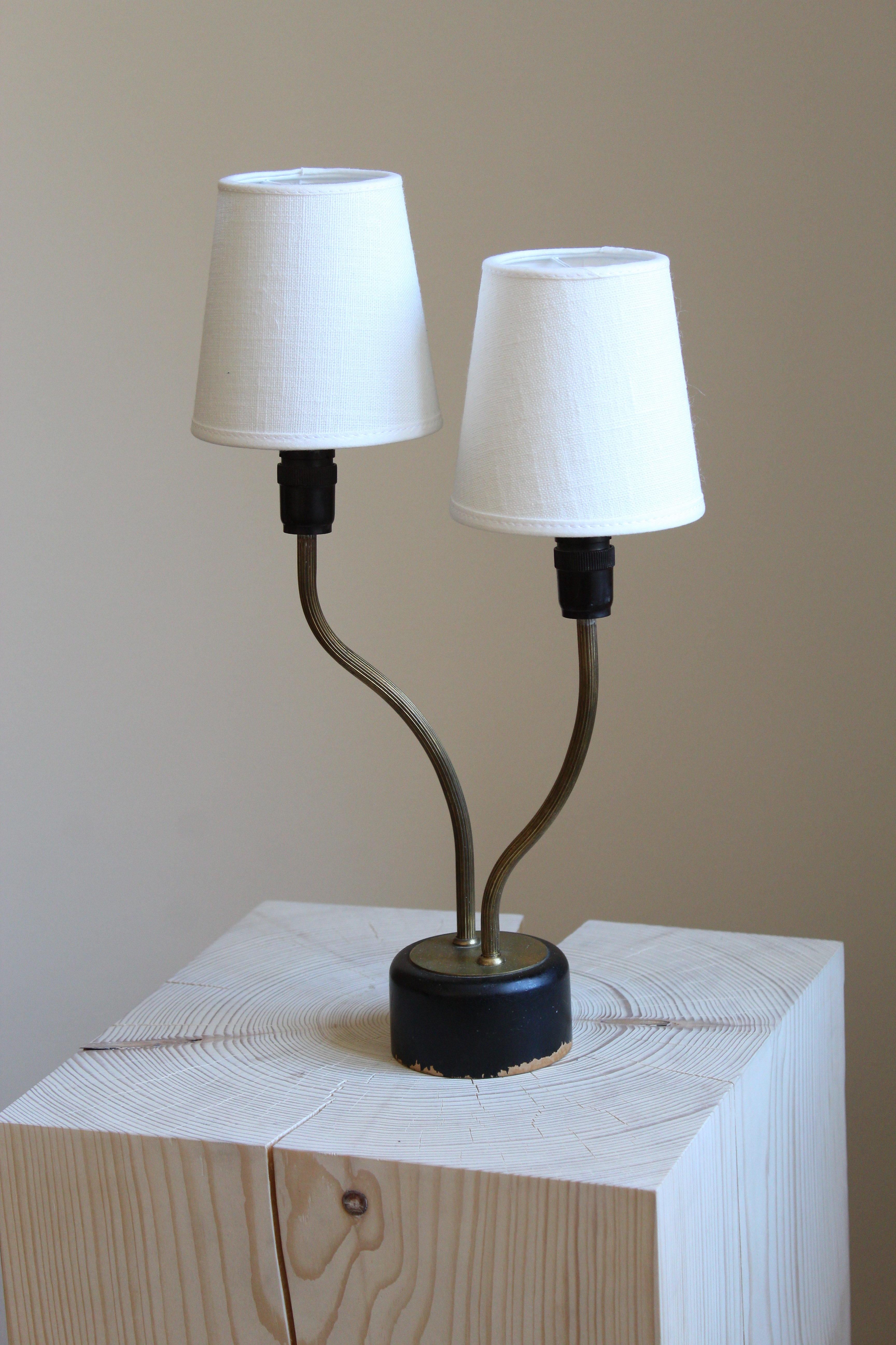 A table lamp. Designed and produced in Sweden, 1950s. Features two organic arms. Brand new linen lampshades.

Other designers of the period include Josef Frank, Hans Bergström, Paavo Tynell, Alvar Aalto, and Kaare Klint.