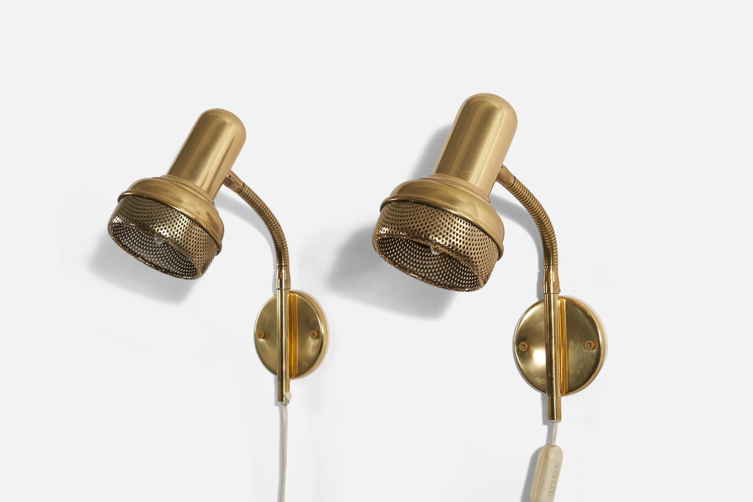 A pair of adjustable brass wall lights produced by a Swedish designer, Sweden, 1960s.