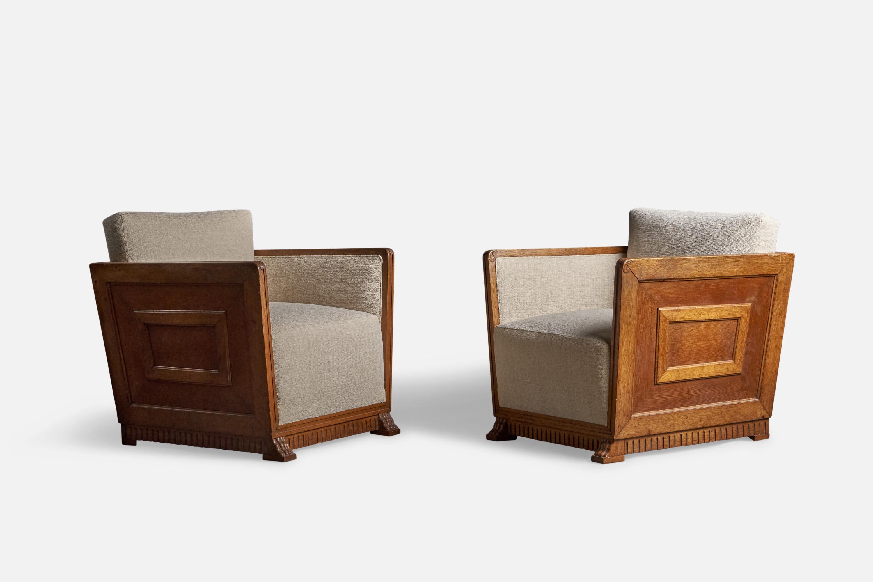 A pair of wood and off white fabric lounge chairs with carved ornamentation, designed and produced in Sweden, 1930s.