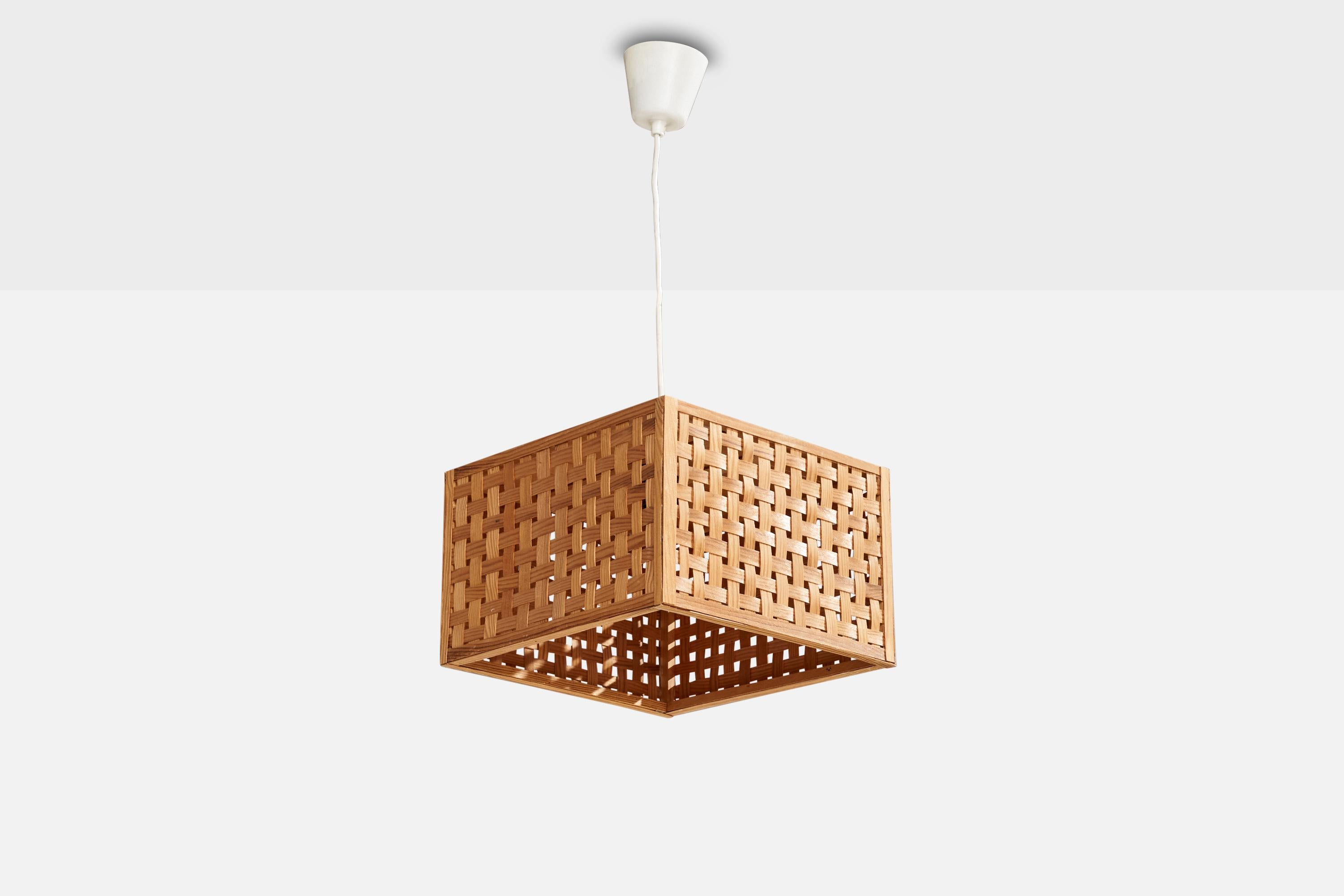 A pine and pine veneer pendant light designed and produced in Sweden, c. 1970s.

Dimensions of canopy (inches): 3.34” H x 3.6” Diameter
Socket takes standard E-26 bulbs. 1 socket.There is no maximum wattage stated on the fixture. All lighting will