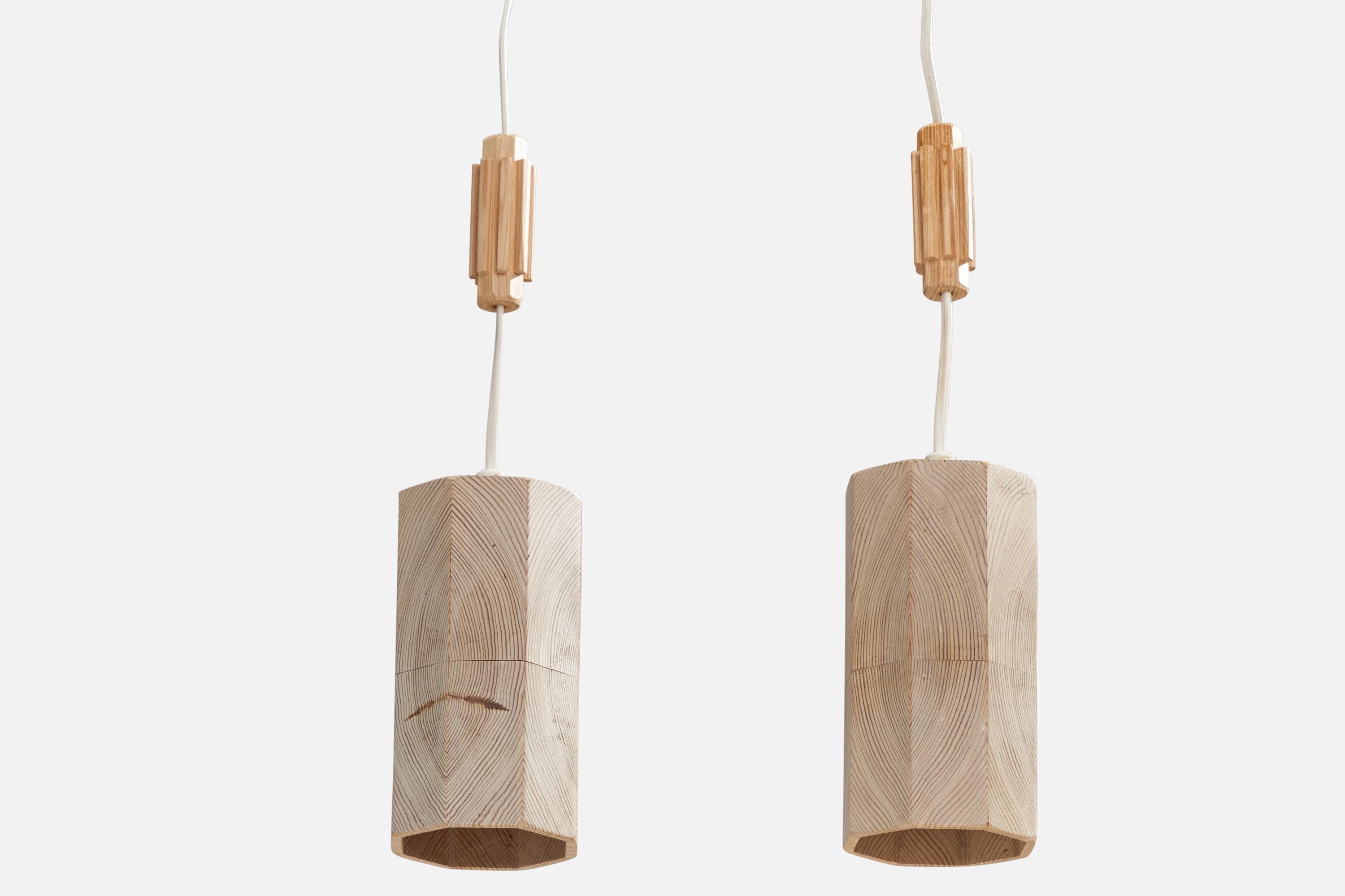 A pair of pine pendant lights designed and produced in Sweden, c. 1970s.

Dimensions of canopy (inches): N/A
Socket takes standard E-14 bulbs. 1 socket.There is no maximum wattage stated on the fixture. All lighting will be converted for US usage.