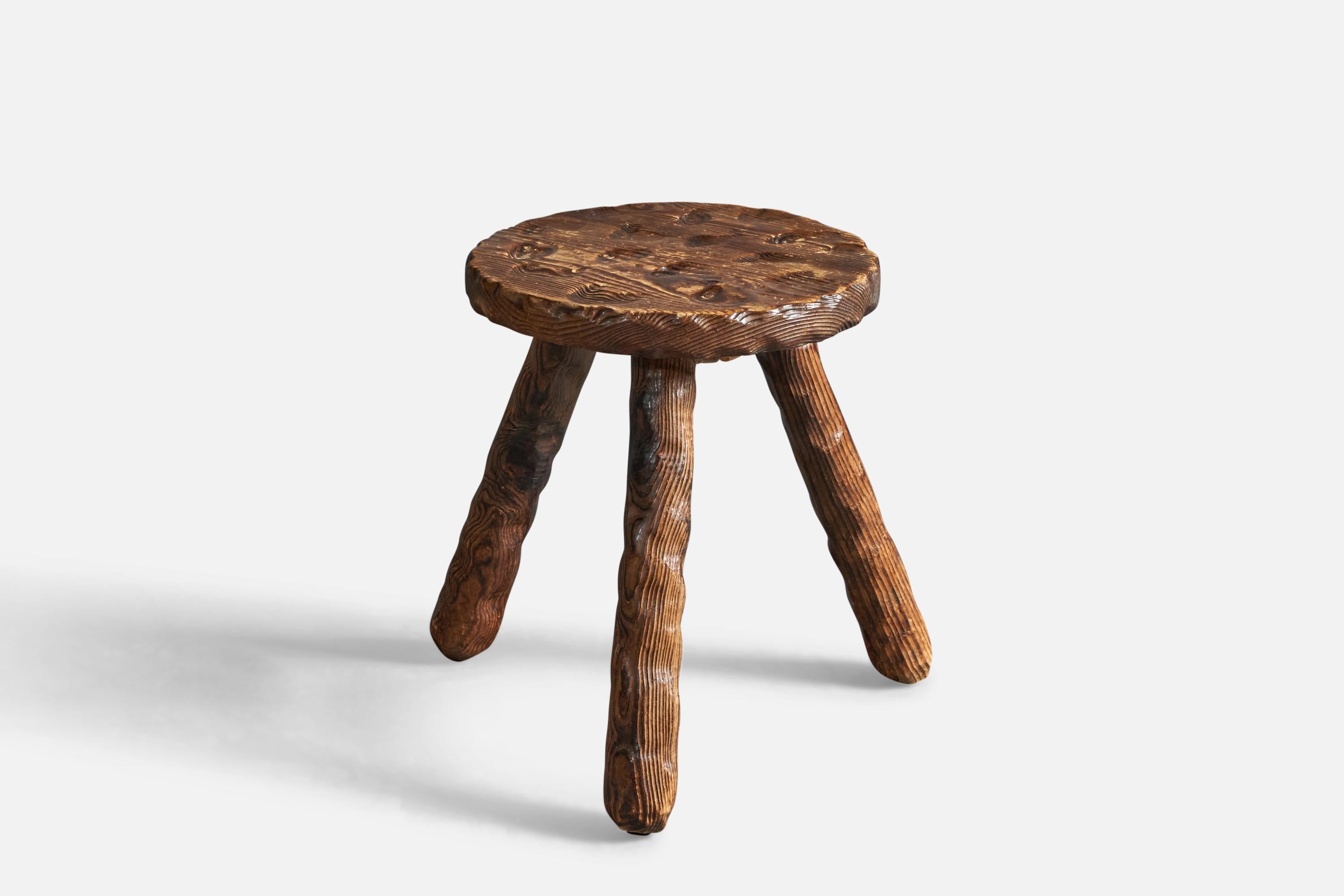 A hand-carved and stained pine stool, designed and produced in Sweden, c. 1970s