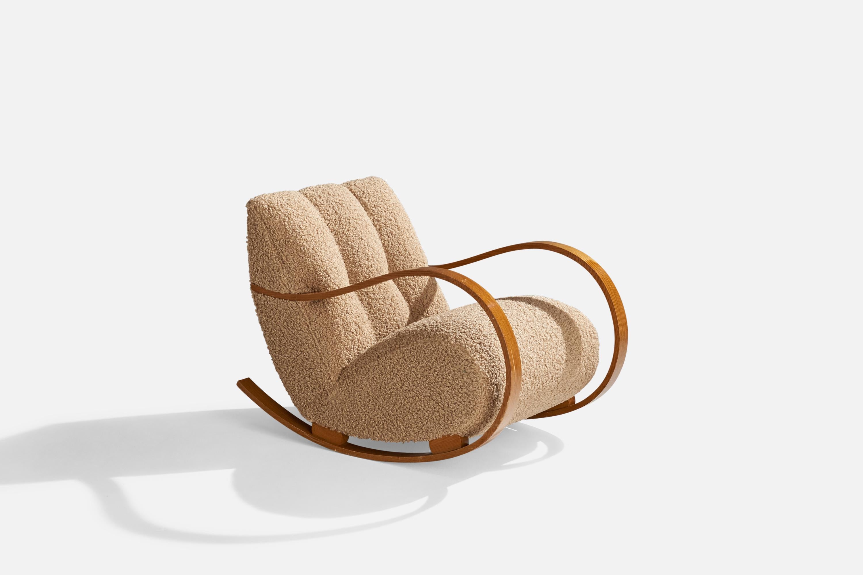 A moulded wood and brown bouclé fabric rocking lounge chair designed and produced in Sweden, 1940s.

Seat height 18”.
Reupholstered in brand new bouclé fabric.