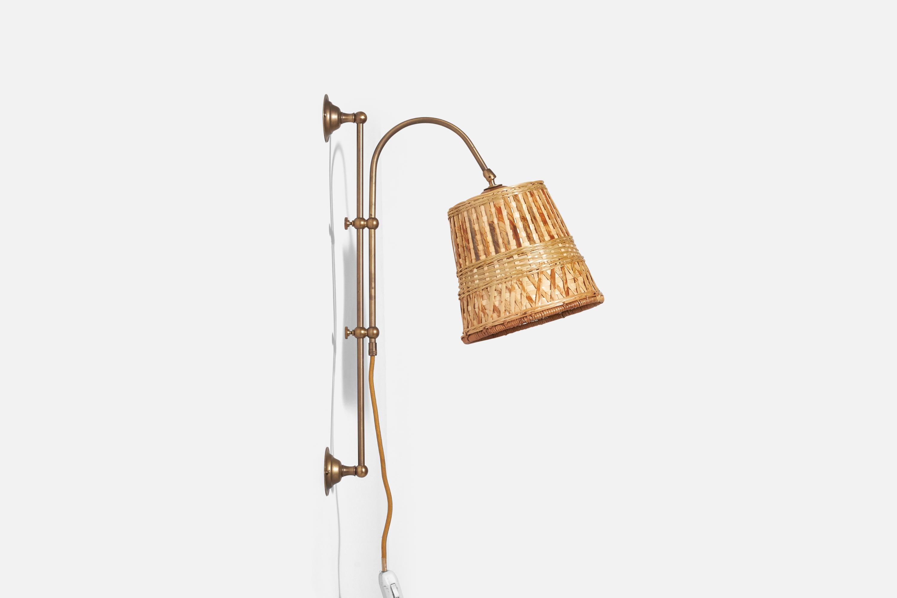 A brass and rattan sconce / wall light designed and produced in Sweden, 1960s.

Sold with Lampshade. Dimensions stated are of Sconce with Lampshade.

Dimensions variable, measured as illustrated in first image.

Dimensions of Back Plate (inches) :
