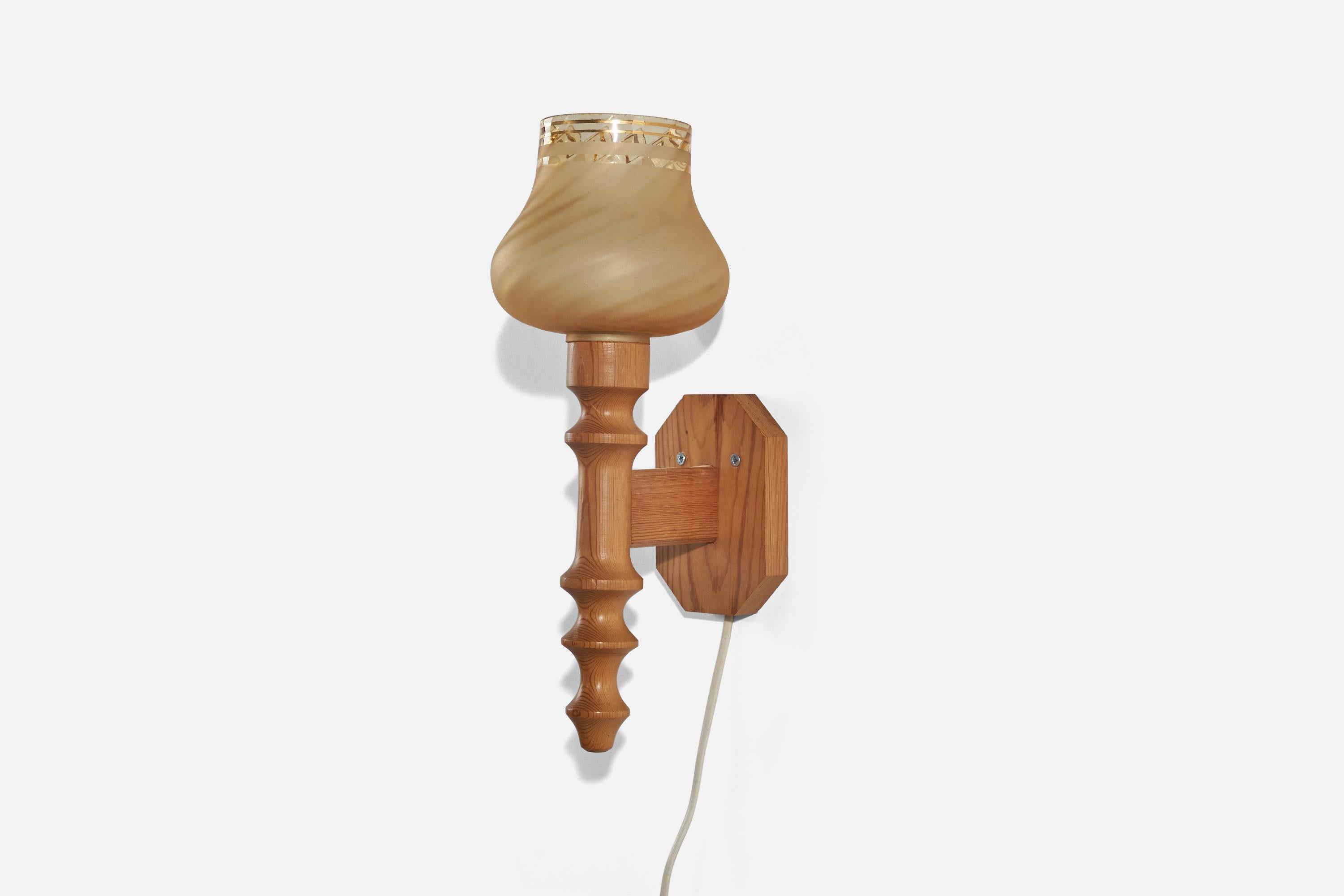 A pine and glass sconce designed and produced in Sweden, c. 1970s. 

Fixture is not hardwired, plug in only. 
Socket takes standard E-26 medium base bulb.
There is no maximum wattage stated on the fixture.