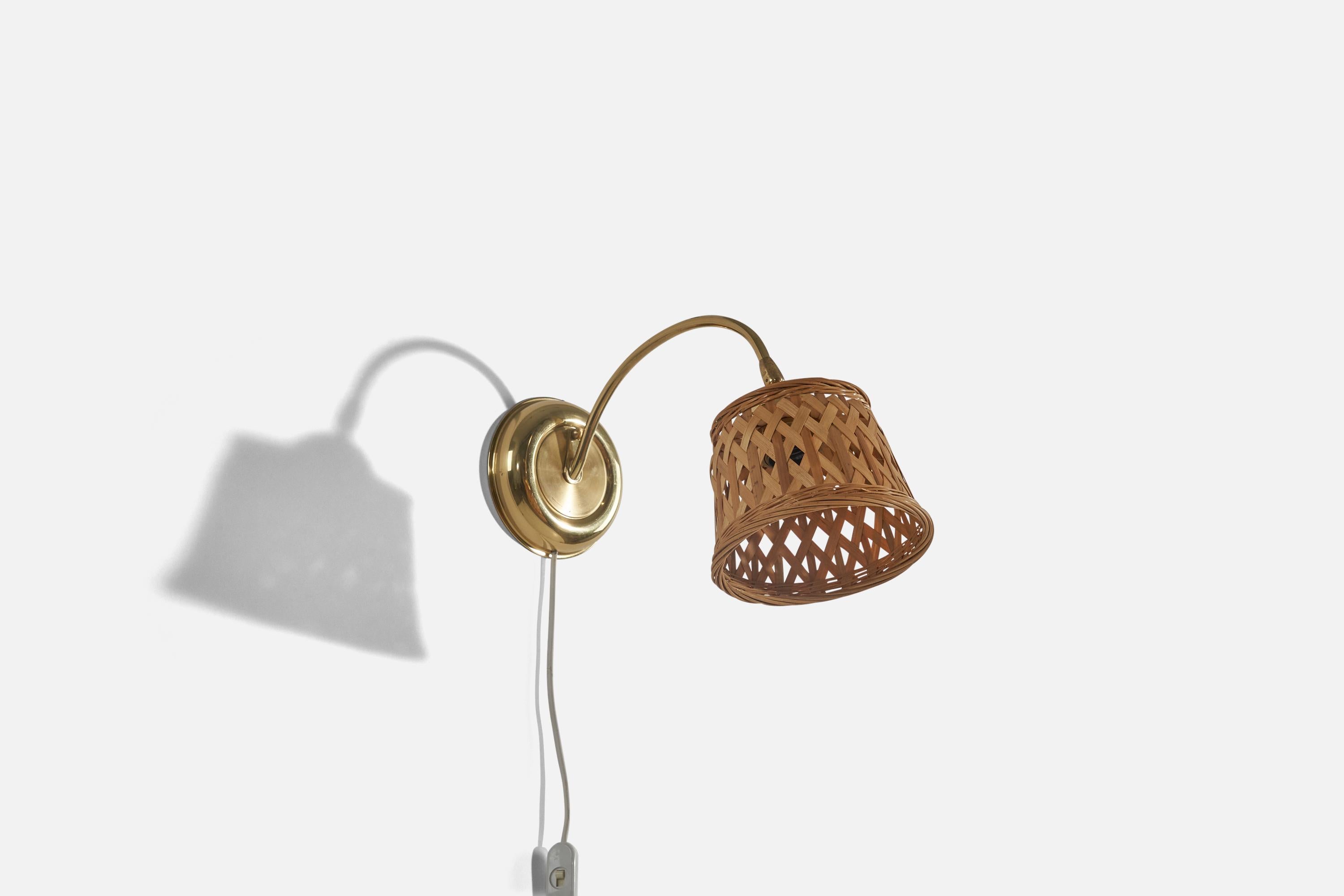 A pair of brass and rattan sconces designed and produced in Sweden, c. 1970s. 

Sold with lampshades. 
Stated dimensions refer to the Sconces with the Shades.
Variable dimensions, measured as illustrated in the first image. 

Dimensions of