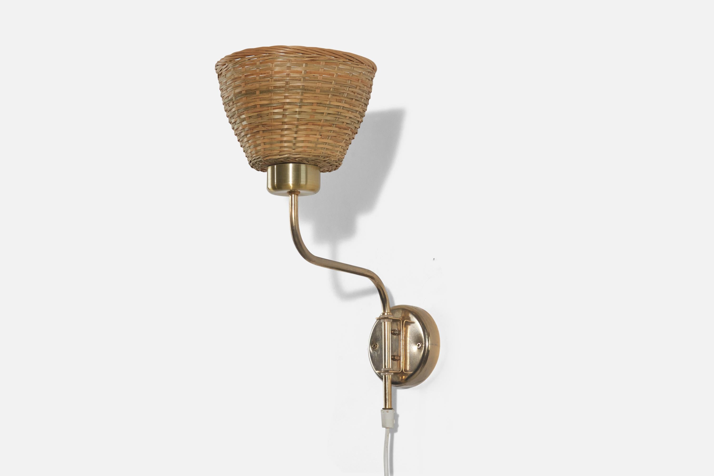 A pair of brass and rattan sconces designed and produced in Sweden, c. 1970s. 

Sold with Lampshades. 
Stated dimensions refer to the sconces with the shades. 
Dimensions of back plate (inches) : 3.93 x 3.93 x 0.87 (height x width x