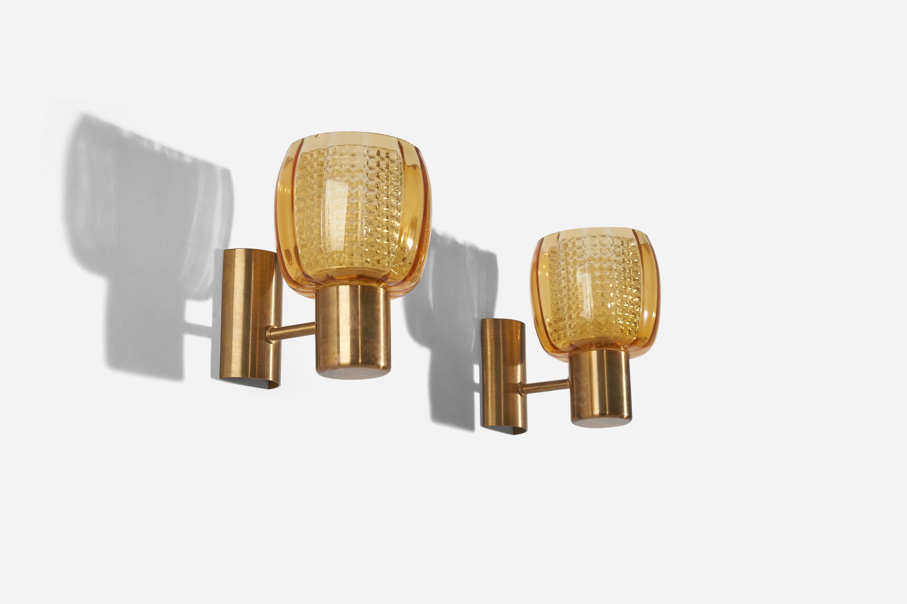 A pair of glass and brass sconces designed and produced in Sweden, c. 1960s.

Dimensions of back plate (inches) : 3.875 x 2.125 x 1 (H x W x D).
