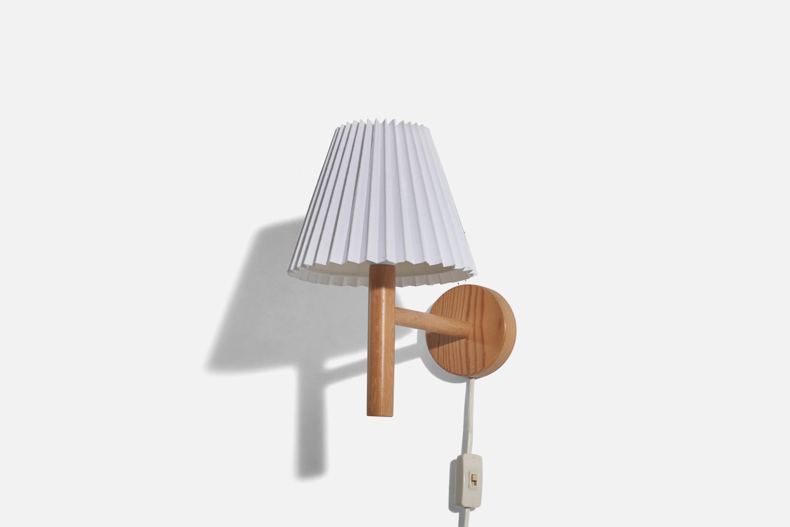 A pair of pine and paper sconces/ wall lights designed and produced in Sweden, c. 1970s. 

Sold with Lampshades. 
Stated dimensions refer to the Sconce with the Shade. 
Dimensions of back plate (inches) : 4.14 x 4.14 x 1.03 (Height x Width x