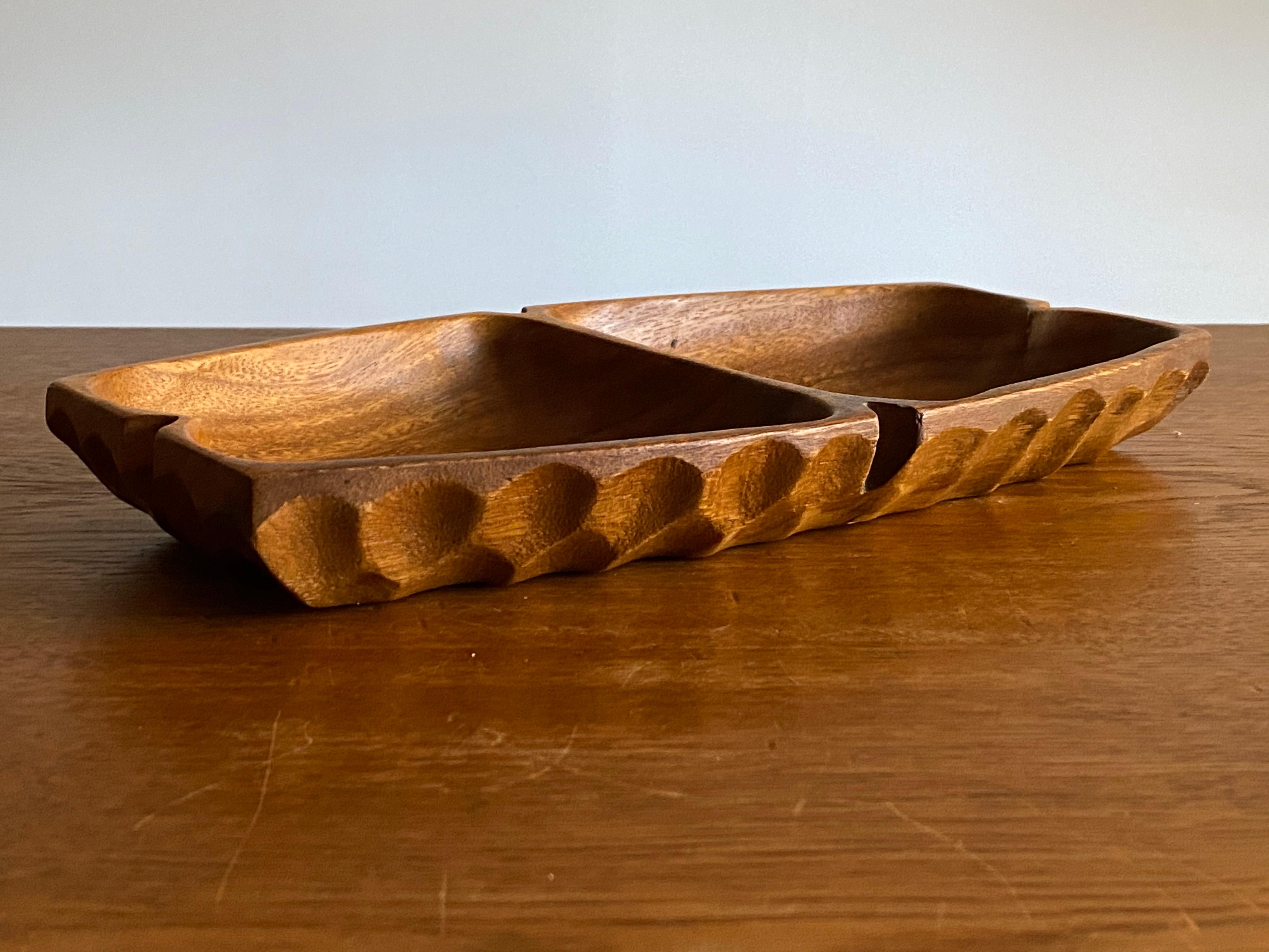 A highly sculptural modernist vide-poche or dish, with two compartments. In solid teak. Unmarked. 

Other woodworkers of the period include Finn Juhl, Peder Moos, George Nakashima, and Alexandre Noll.