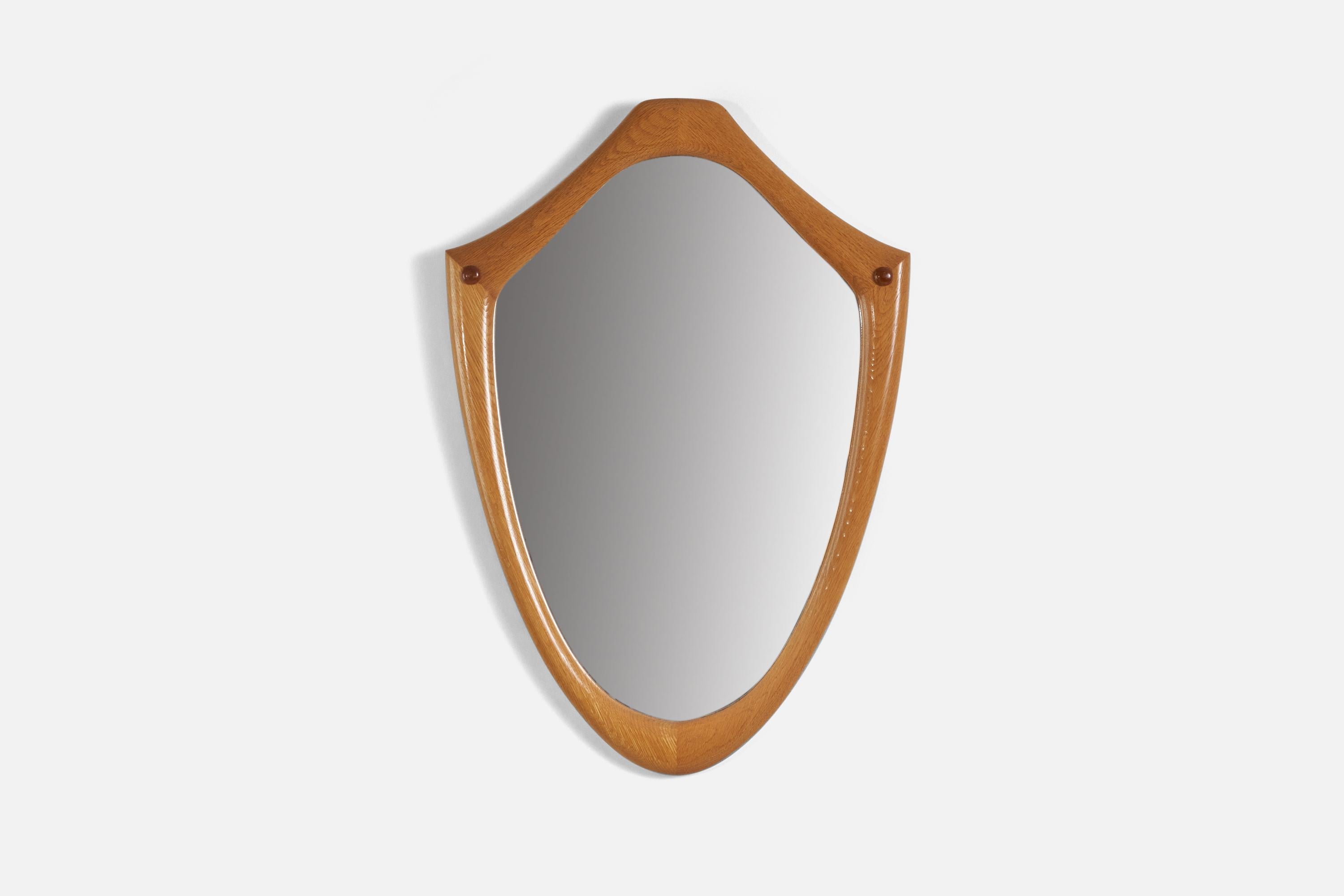 An oak wall mirror designed and produced in Sweden, 1950s. 