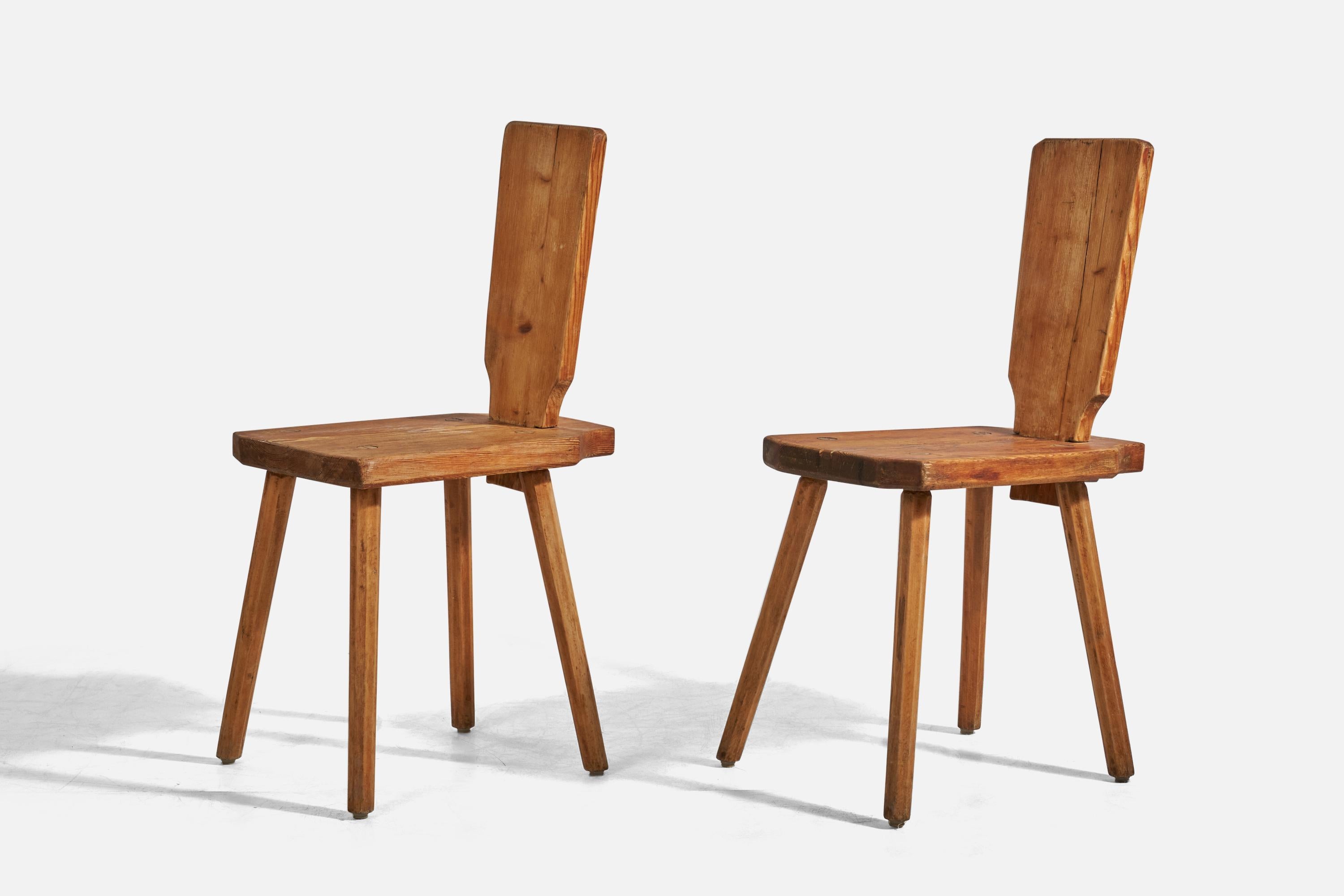 A pair of solid pine side chairs designed and produced in Sweden, c. 1960s. 