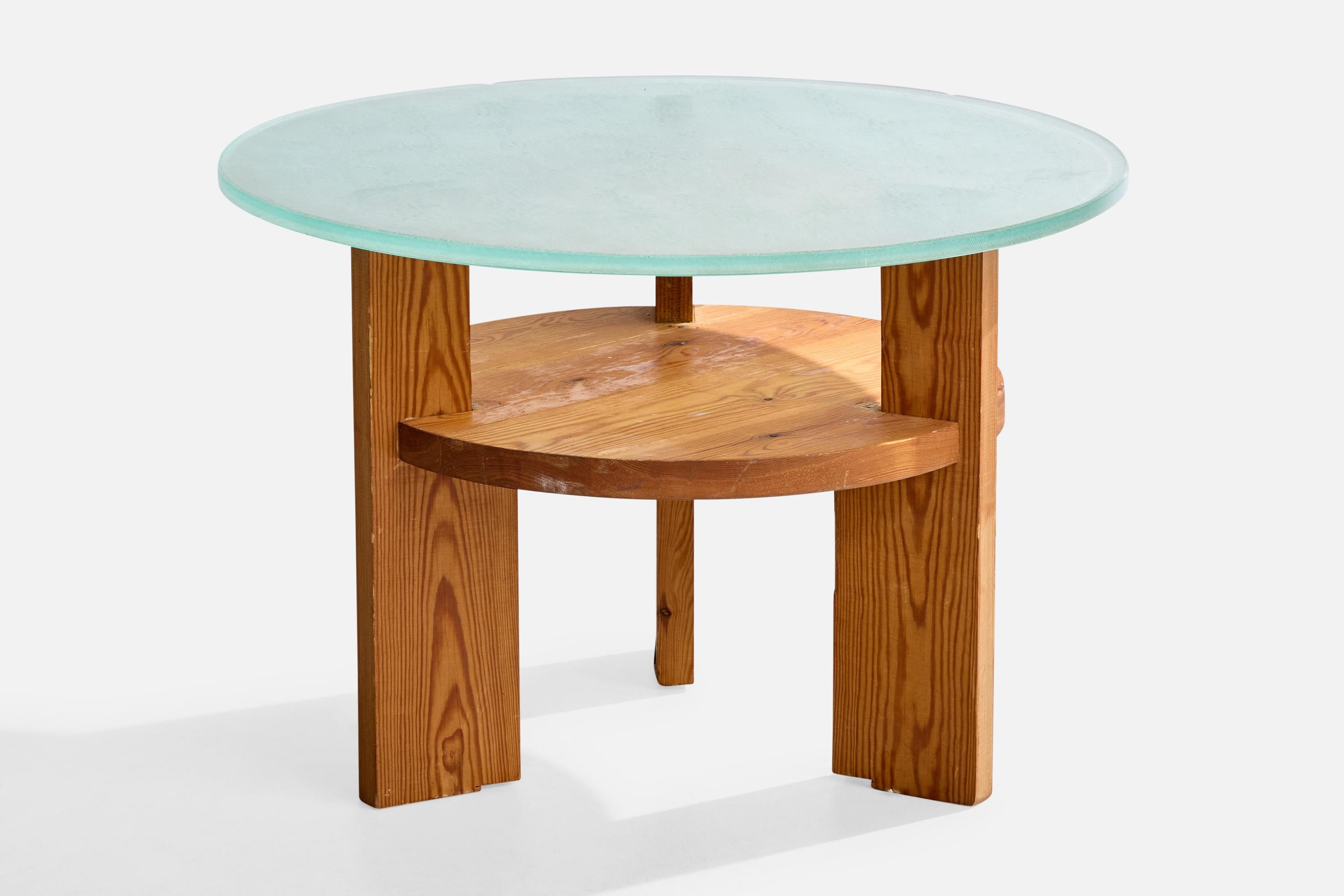 A pine and sand-blasted glass side table designed and produced in Sweden, c. 1930s.

Small chips in glass in a few places around the edge.

Overall Dimensions (inches): 21.75