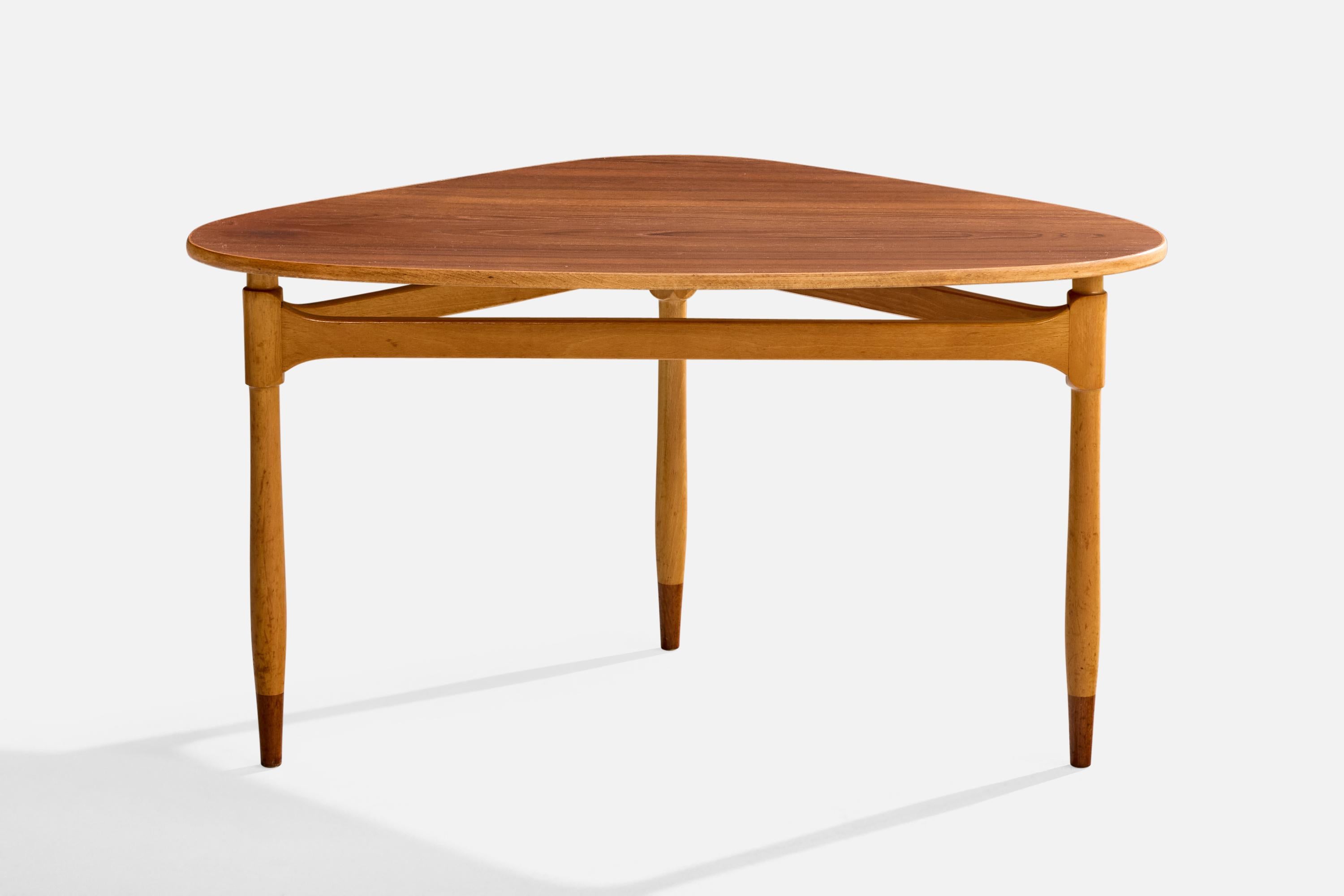 A wood side table designed and produced in Sweden, c. 1950s.

Overall Dimensions (inches): 21.75