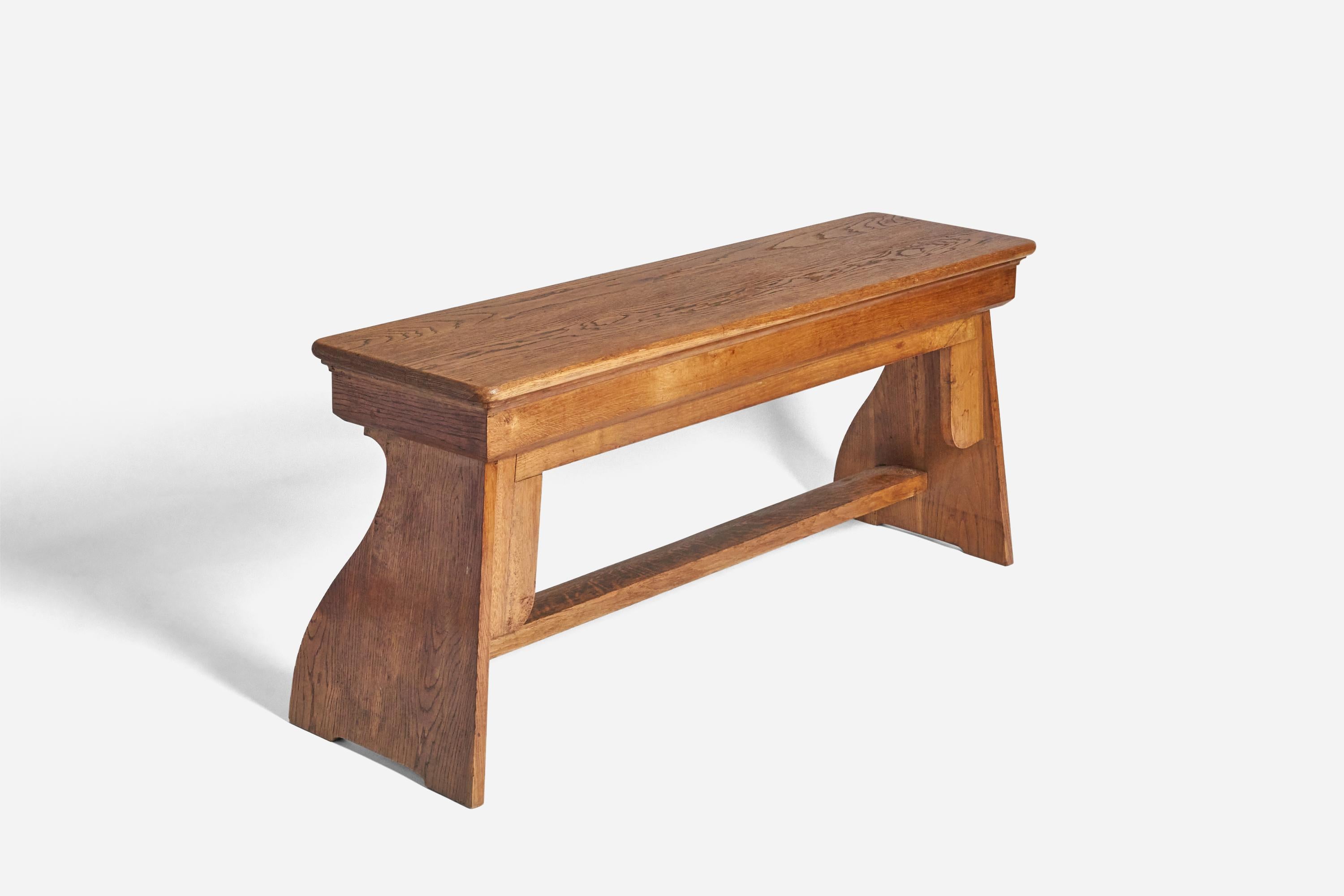 A sizable, solid oak bench designed and produced in Sweden, c. 1920s. 