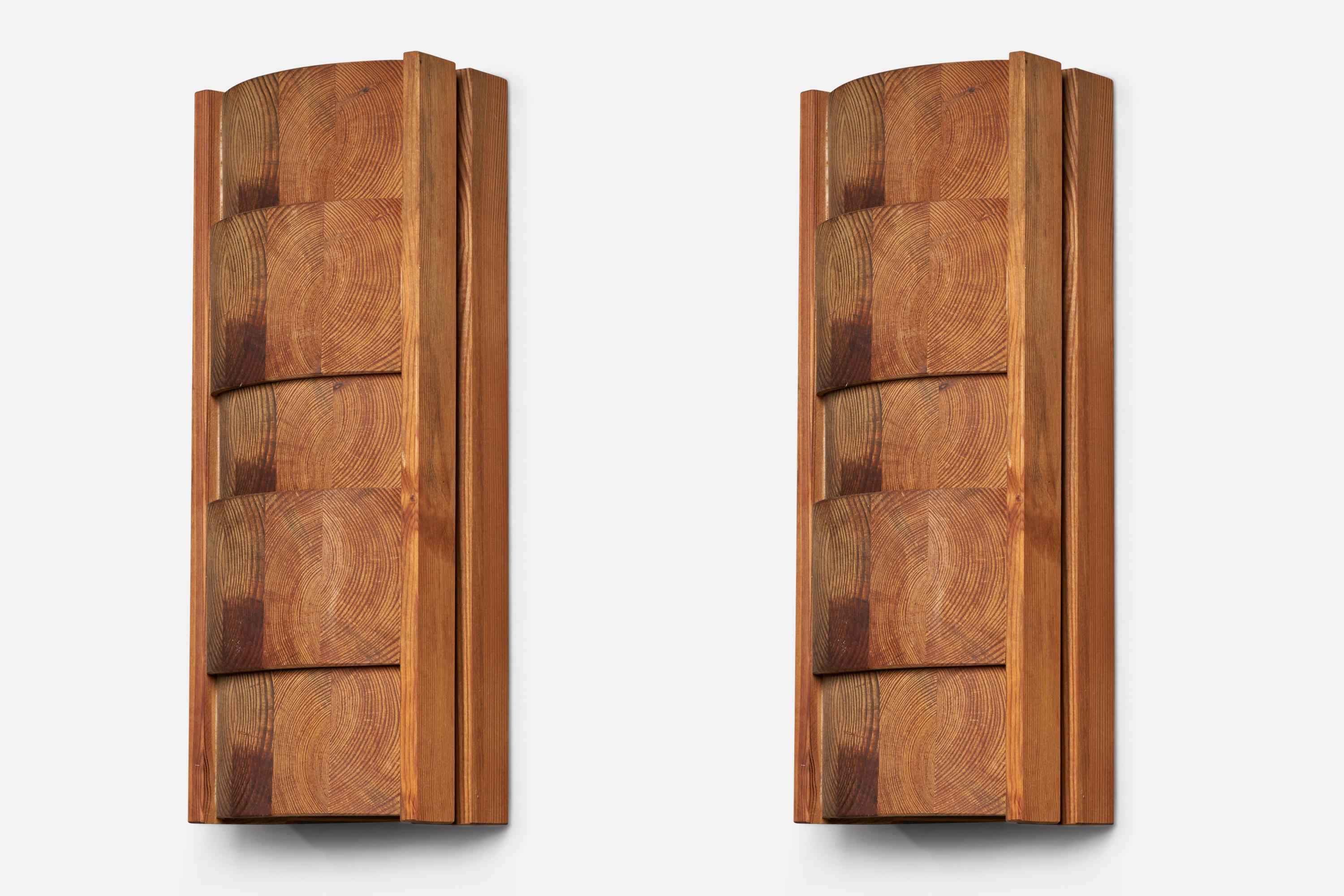 A pair of sizeable pine wall lights, designed and produced in Sweden, c. 1970s.

Overall Dimensions (inches): 20.5