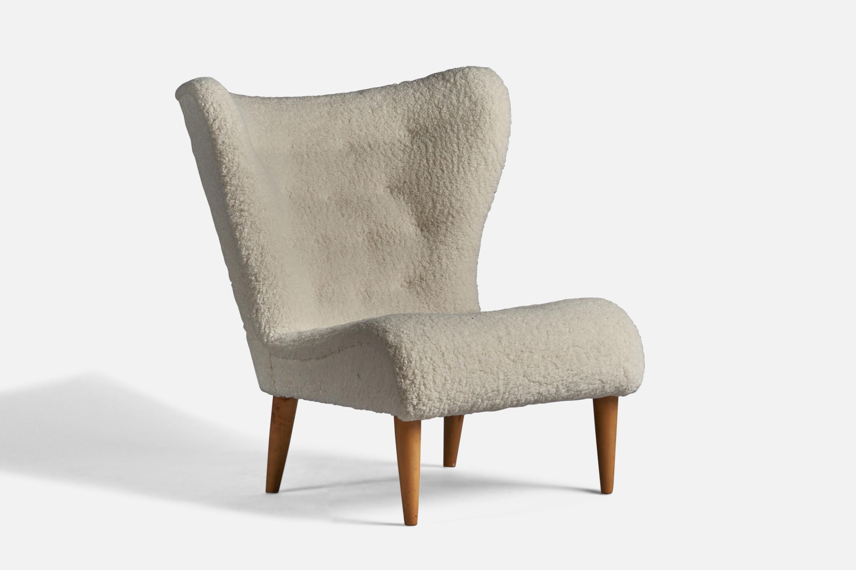 A white bouclé and wood lounge chair or slipper chair designed and produced in Sweden, 1940s.

15