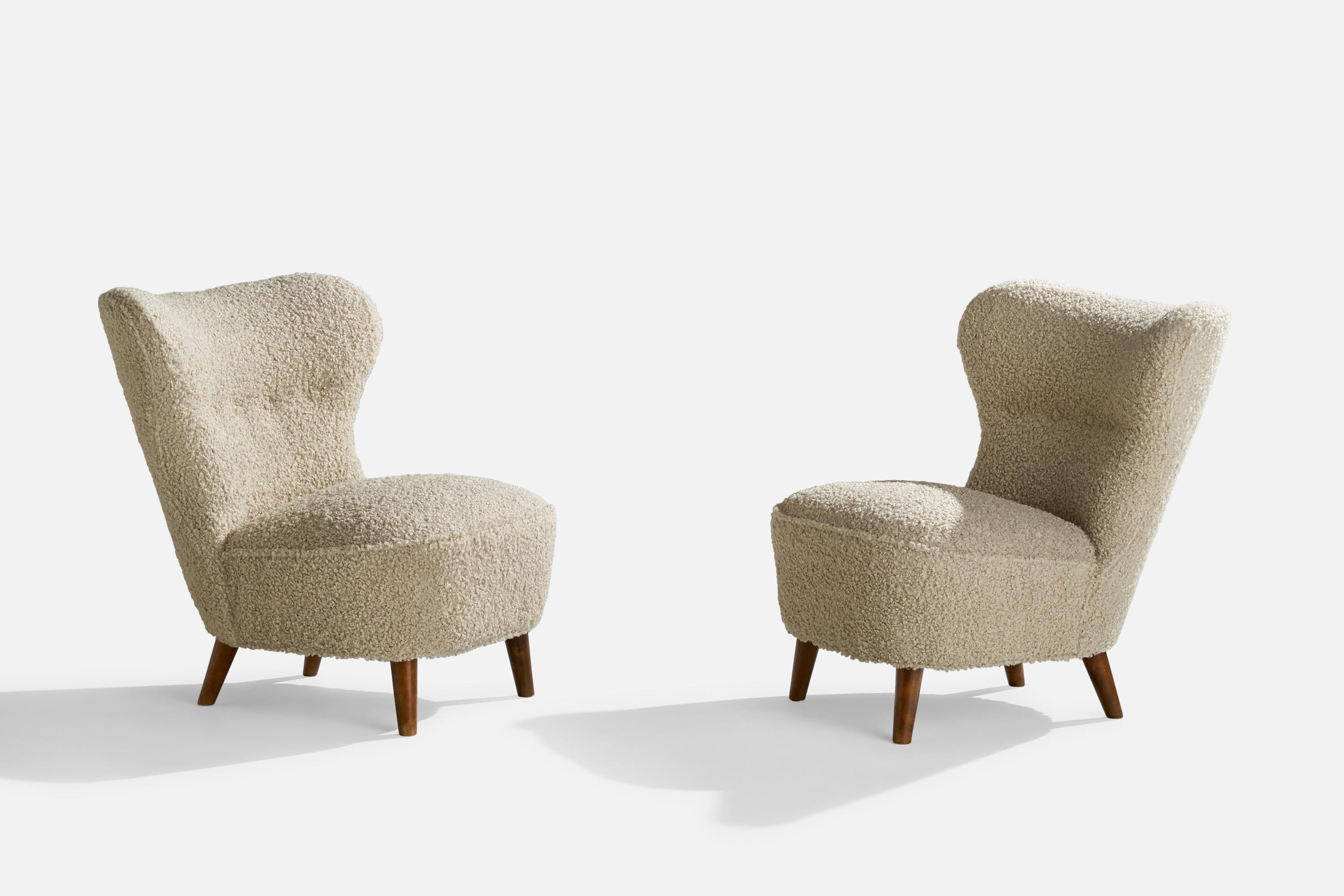 A pair of stained oak and white bouclé fabric slipper lounge chairs designed and produced in Sweden, 1940s.

Seat height 16”.