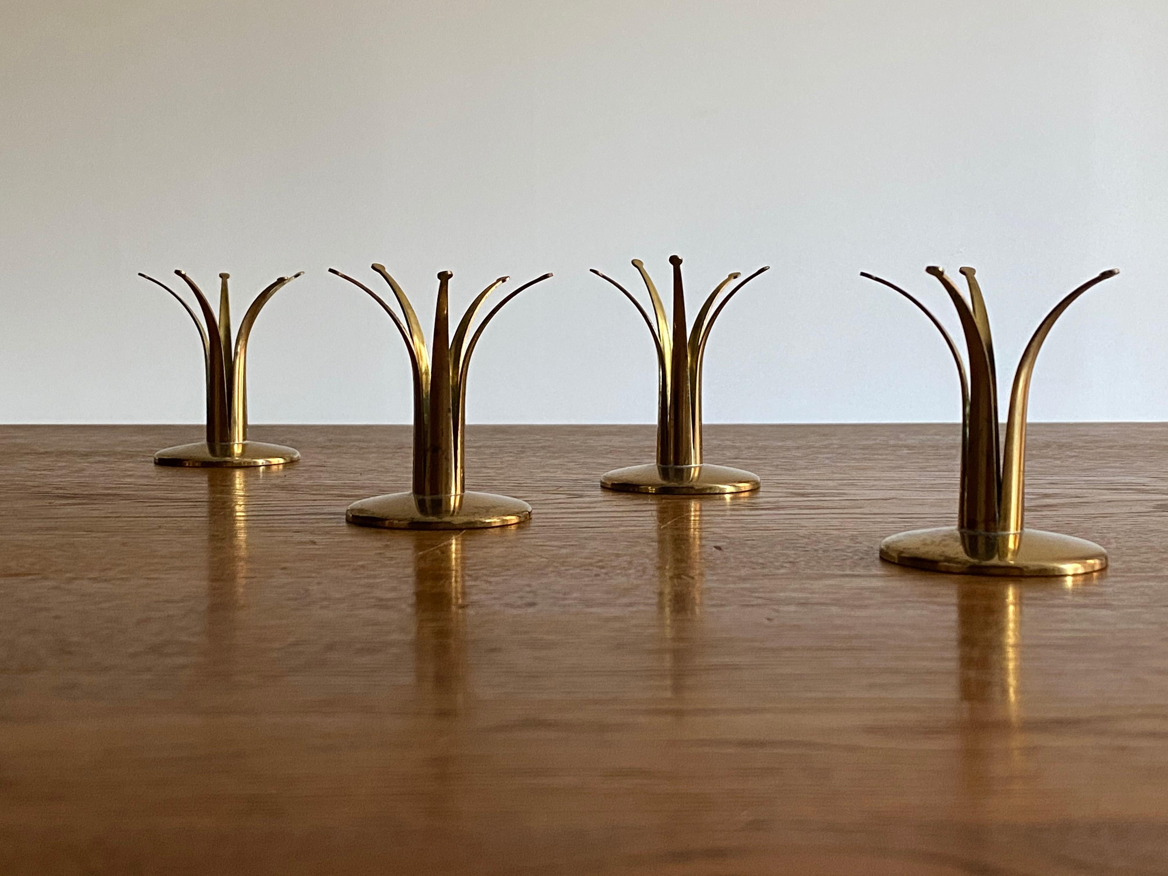 A set a 4 small brass candlesticks. Produced in Sweden, 1950s.

Other designers of the period include Paavo Tynell, Kaare Klint, Hans Agne Jacobsen, and Alvar Aalto.