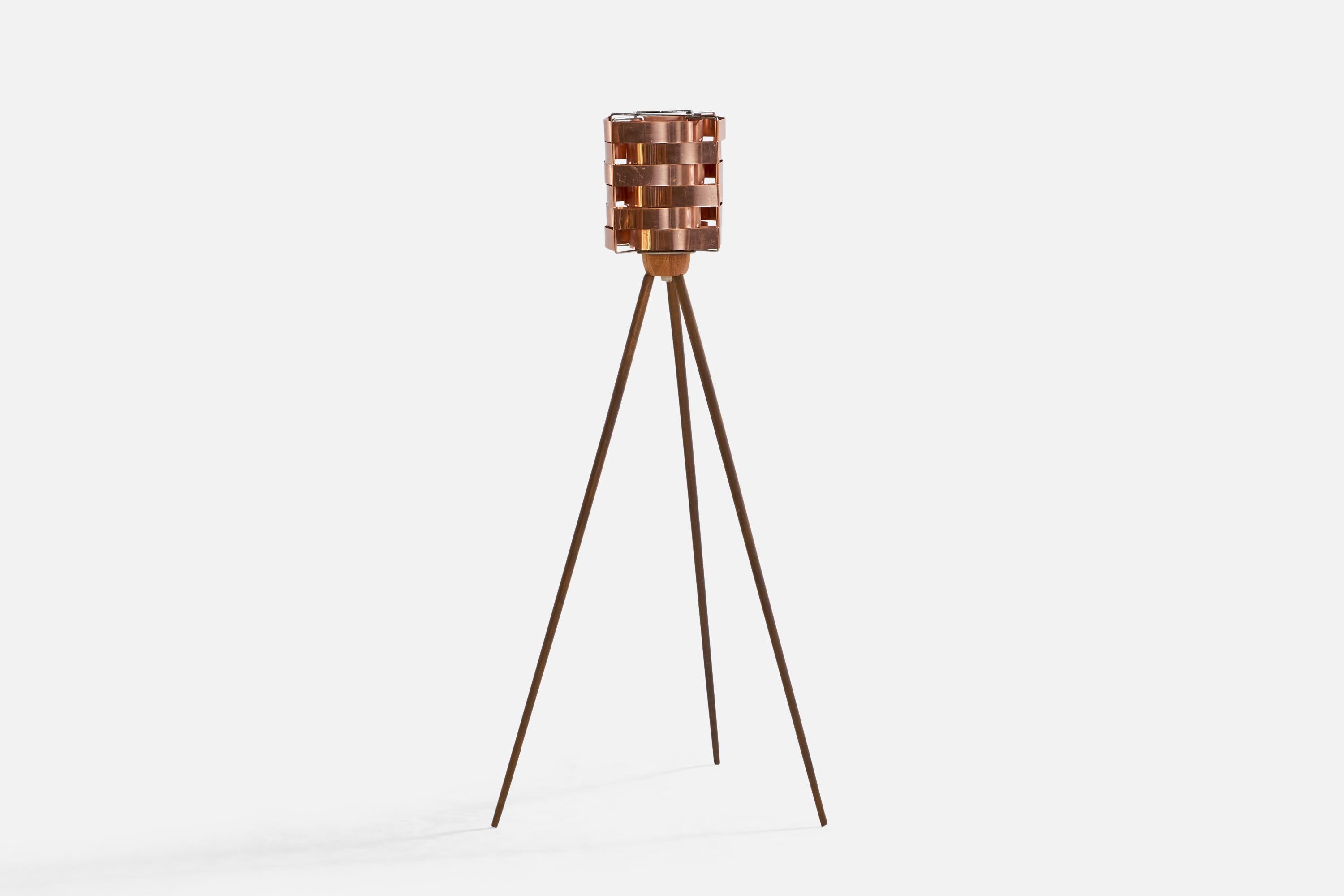 A small teak and copper floor lamp designed and produced in Sweden, 1950s.

Note cord feeds from underside of socket.

Overall Dimensions (inches): 39.75” H x 18.75” W x 17” D
Bulb Specifications: E-26 Bulb
Number of Sockets: 1
All lighting will be
