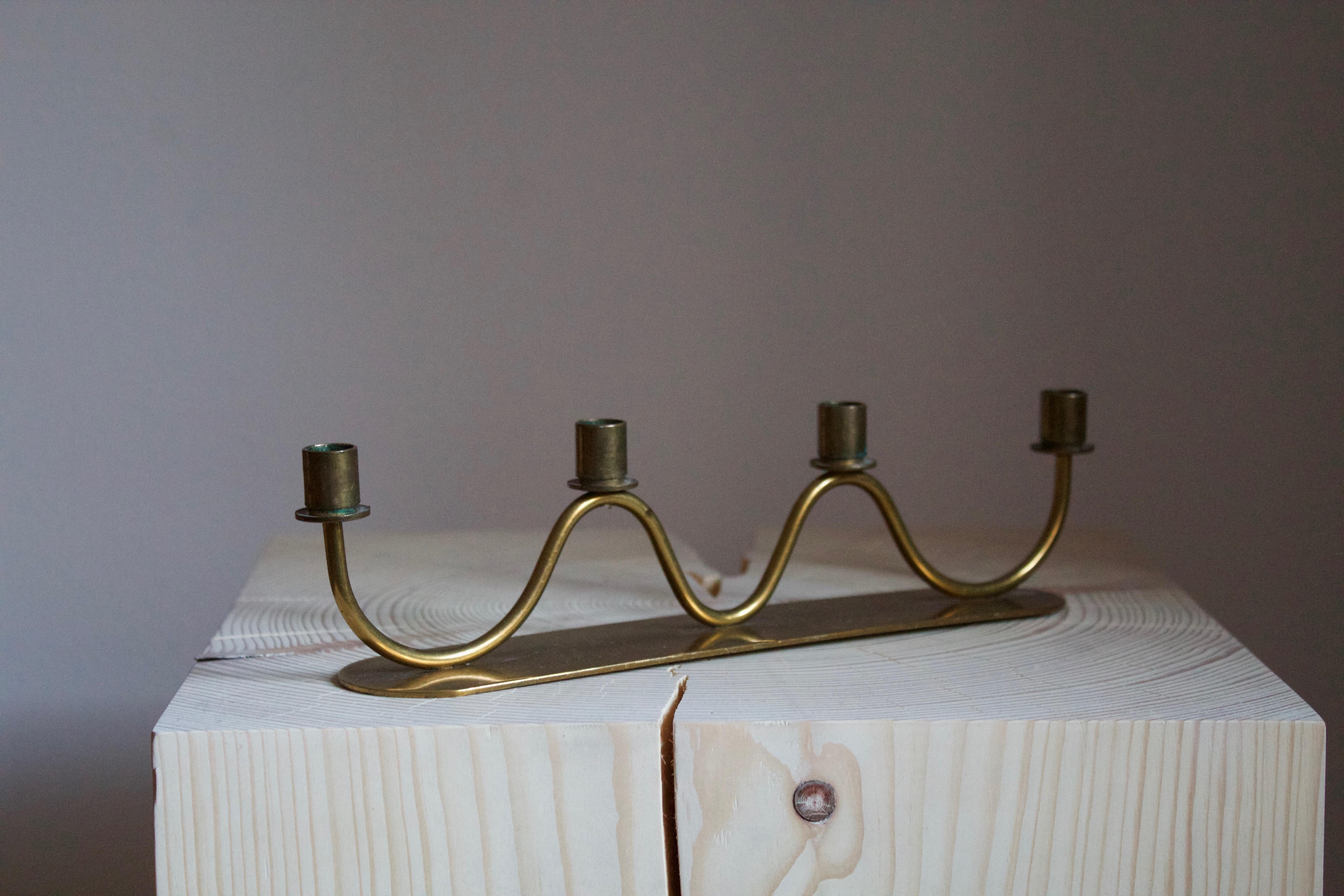 A small organic candelabra, Sweden, 1950s. In brass

Other designers of the period include Piet Hein, Paavo Tynell, Josef Frank, and Jean Royere.

 