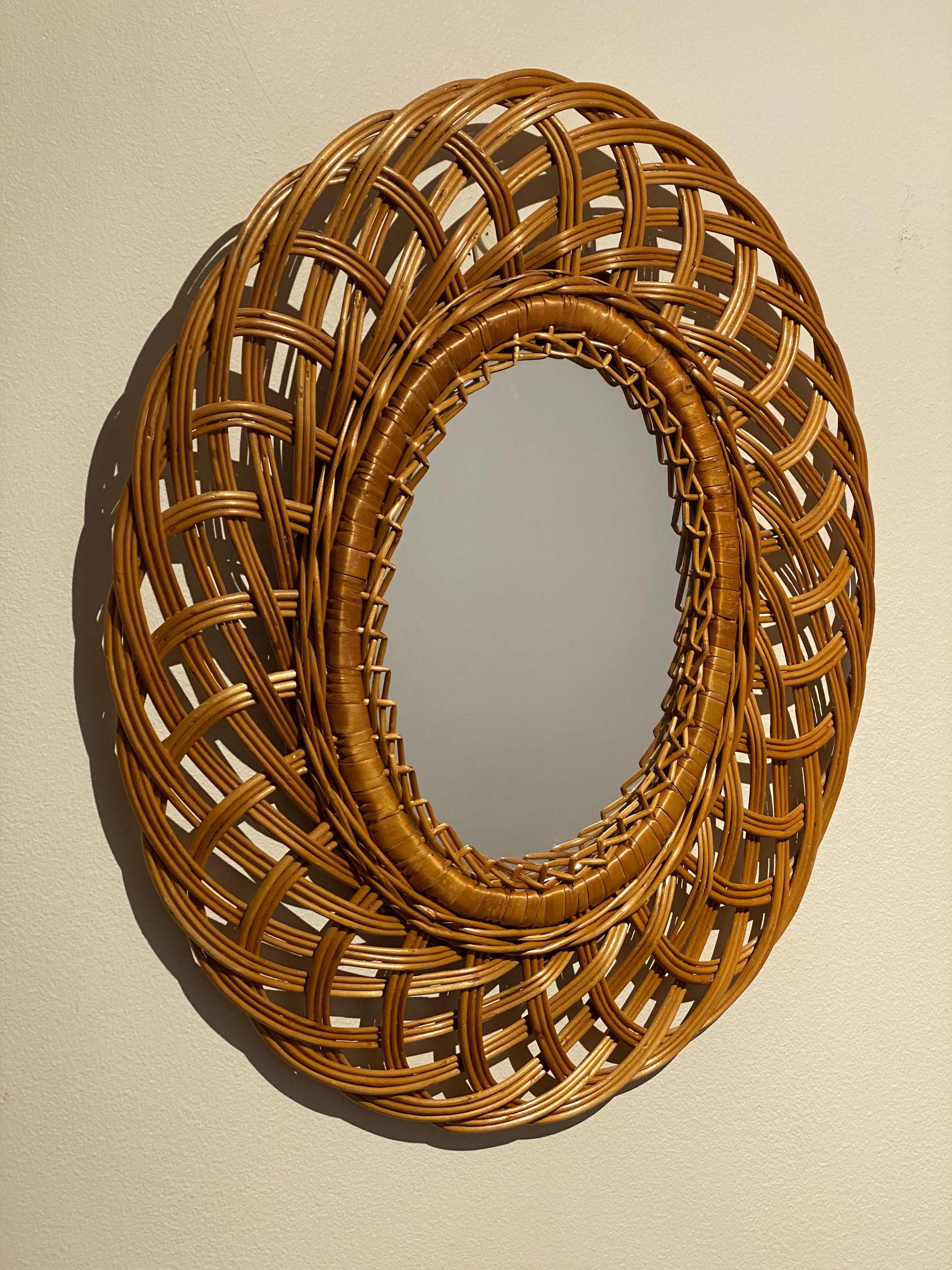 A small and light wall mirror, in woven wicker, Swedish, 1960s.

Other designers of the period include Josef Frank, Fontana Arte, and Line Vautrin.