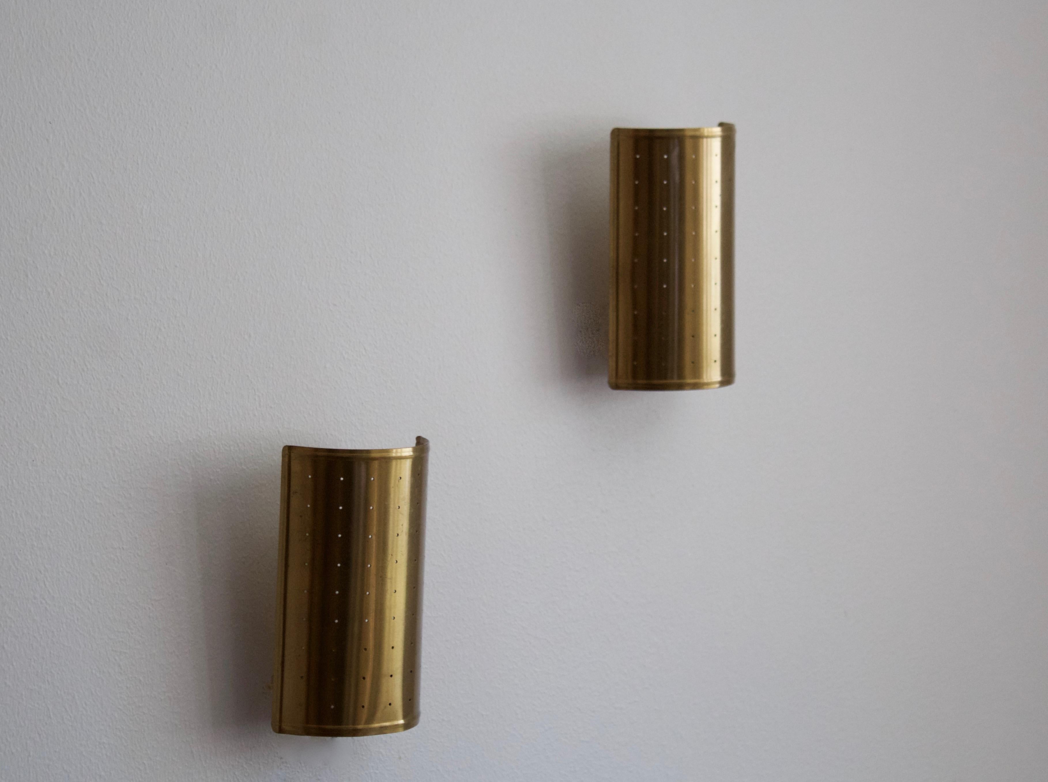 A pair of wall lights / sconces. Designed and produced in Sweden, c. 1940s. Brass screens rest on original porcelain wall mounts

Other designers of the period include Paavo Tynell, Jean Royère, Hans Bergström, Hans-Agne Jakobsson, and Kaare